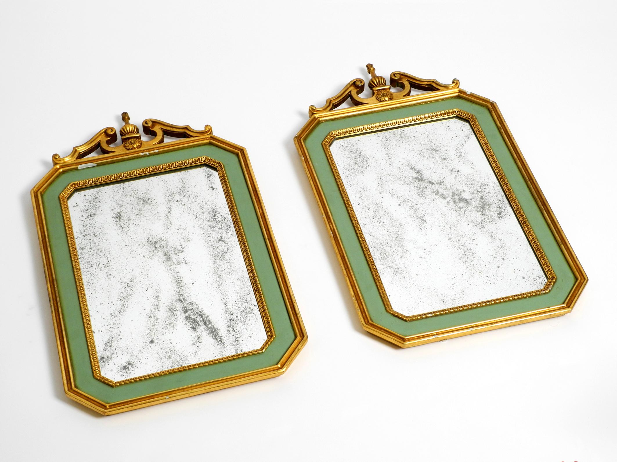 Two beautiful mid century wall mirrors made of wood.
Very high quality workmanship with a great patina. Made in Italy.
Frame is made entirely of wood, partly painted green and partly gold-plated.
Each mirror glass has become spotty blind.
Great