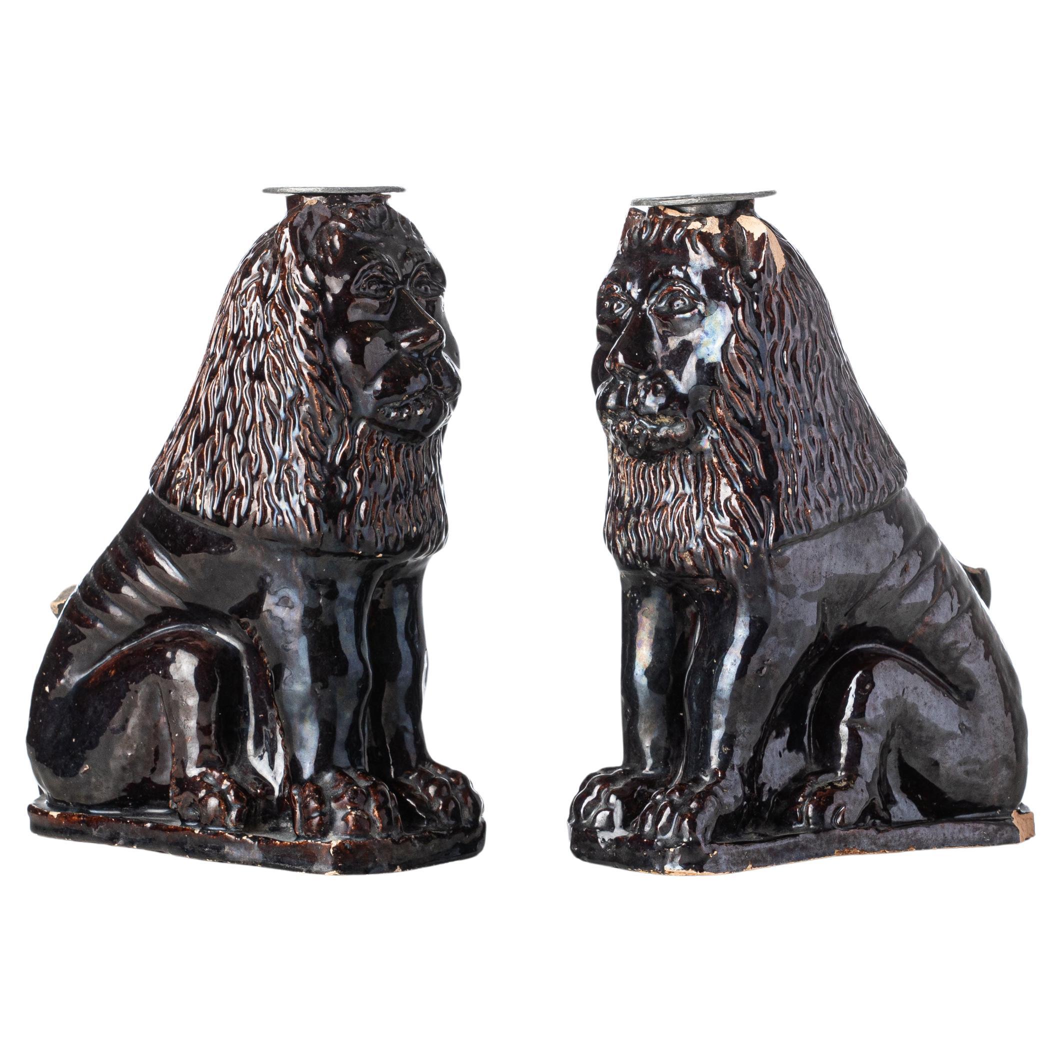 Two Black Glazed Terracotta Lions Serve as Candleholders, early 1800s France