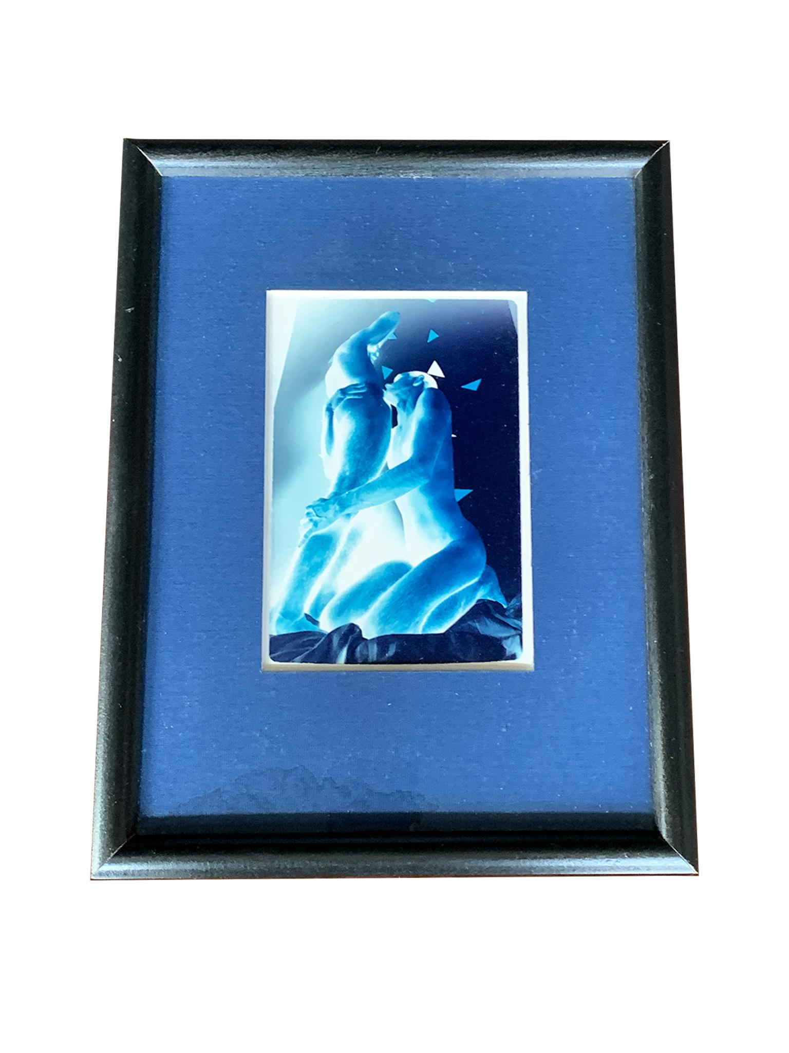 This small cyanotype photograph is by the late American artist Steph Gorkii. It's a beautiful, sensual image of two figures in an intimate embrace. Gorkii depicts them in the negative, their bodies abstracted and glowing, creating a powerful, stark