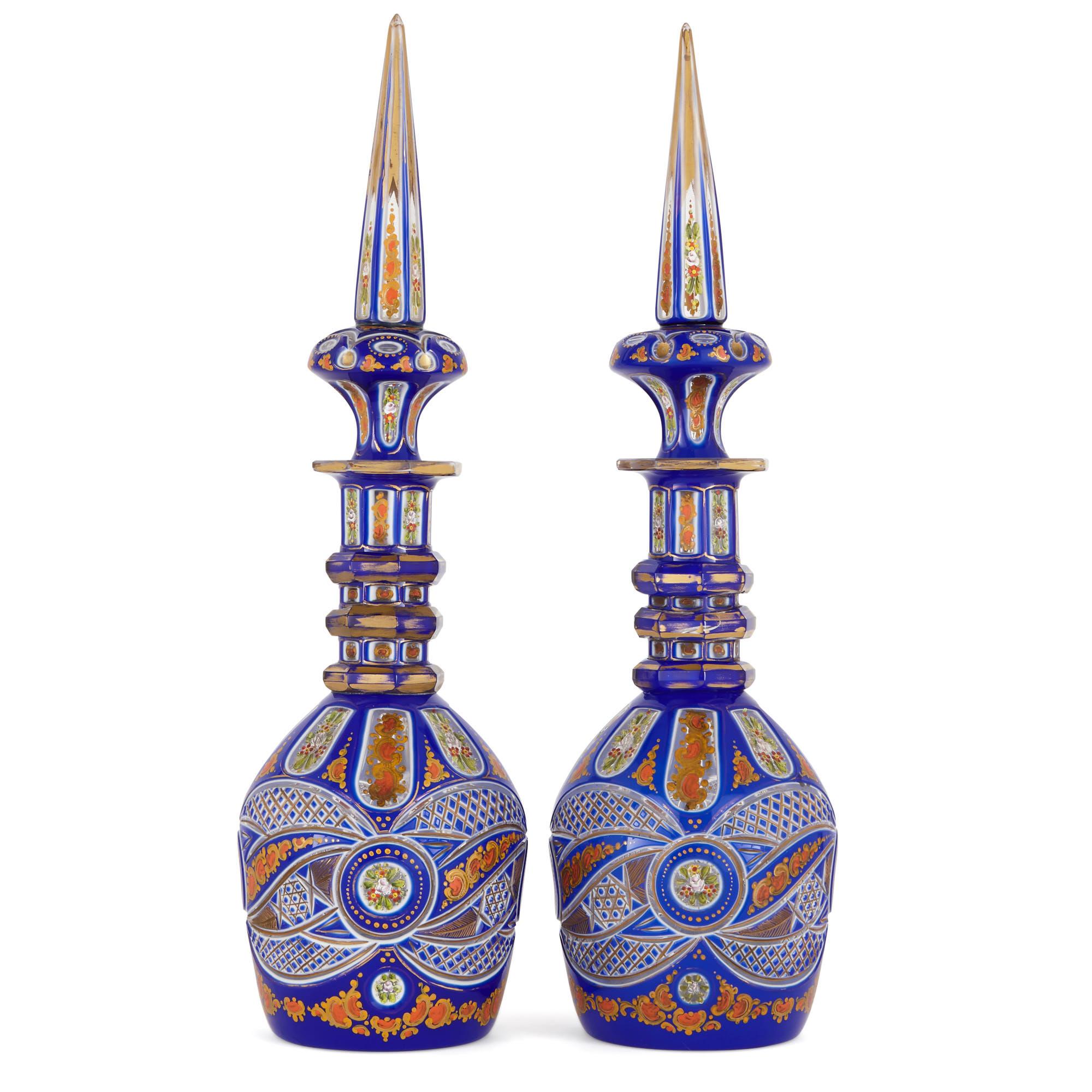 These wonderfully colourful glass decanters were created in the late 19th century in Bohemia (modern-day Czech Republic). For centuries, Bohemian glass has been prized for its high-quality workmanship and beautiful ornamentation.

The two