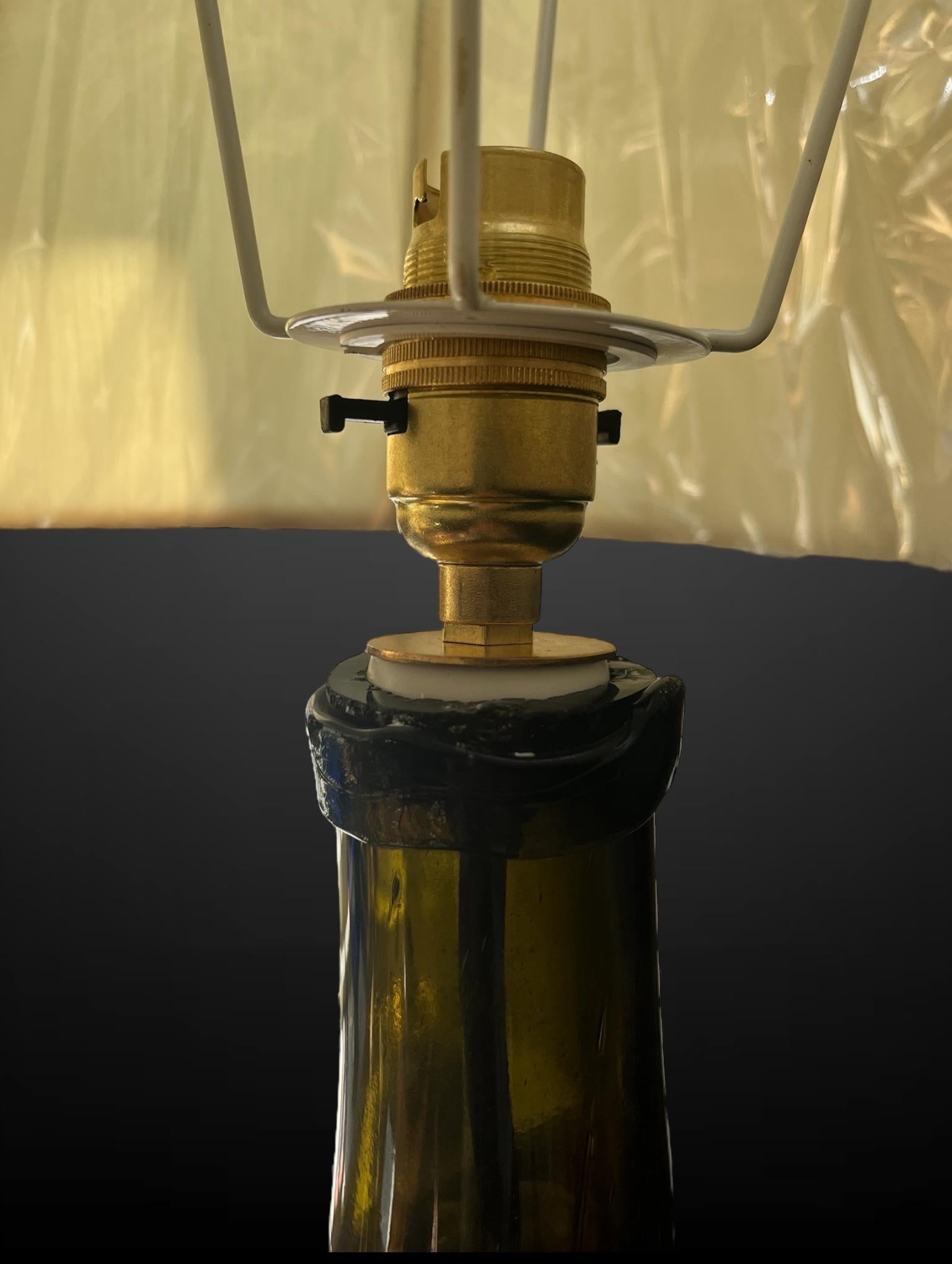 Two Bottle Green Carboy converted into lamps.

When the light passes through their unique forms, the bottle green almost turns to lime. Each bottle with its own movement in the glass, creates a distinguished shape and shadowed interior.

With black