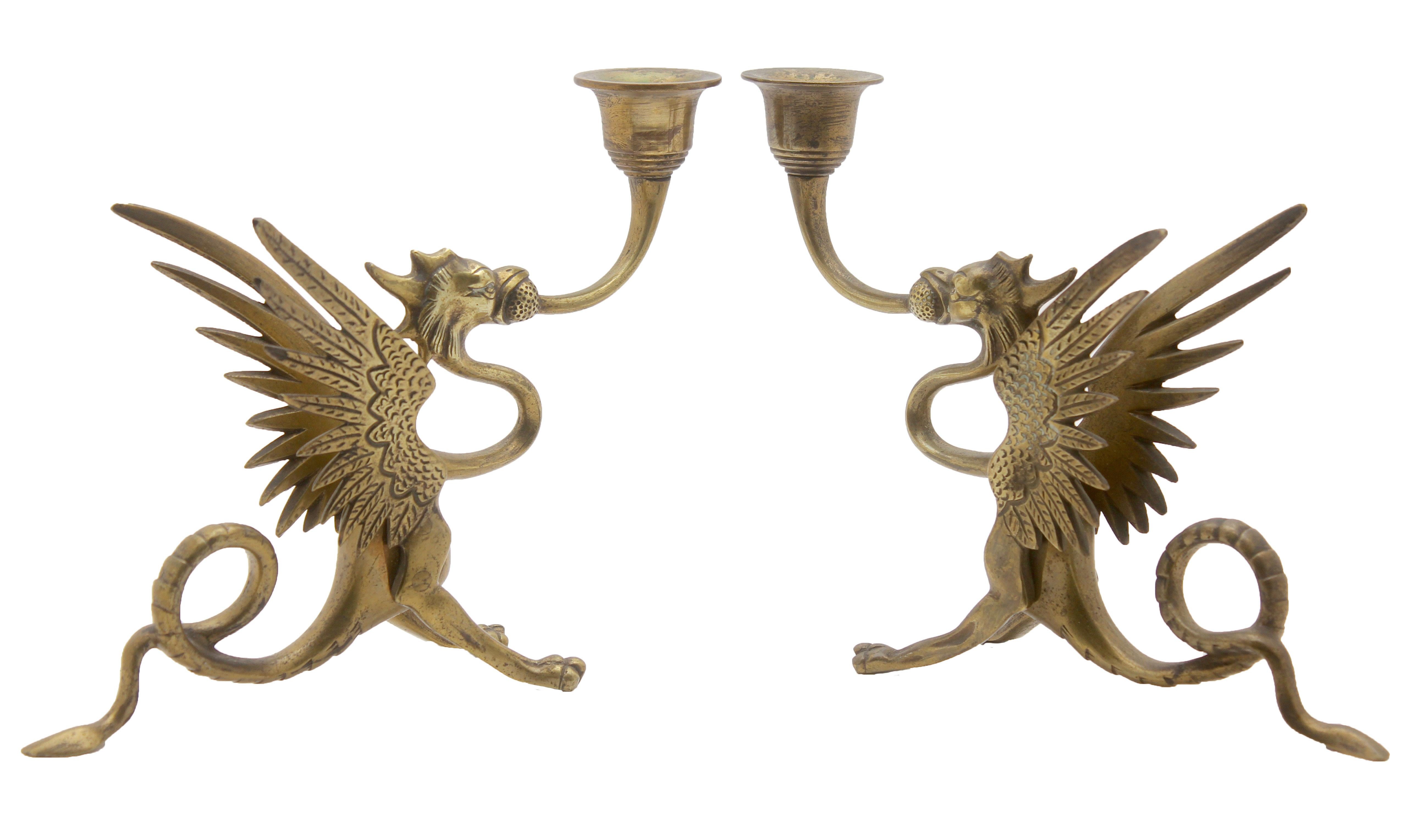 Two brass counterbalanced candlesticks in the shape of dragons.

This type of candlestick is designed to hold the candle over the edge of
a shelf, mantelpiece, or piano. The popular design is found in a range
of similar designs which have