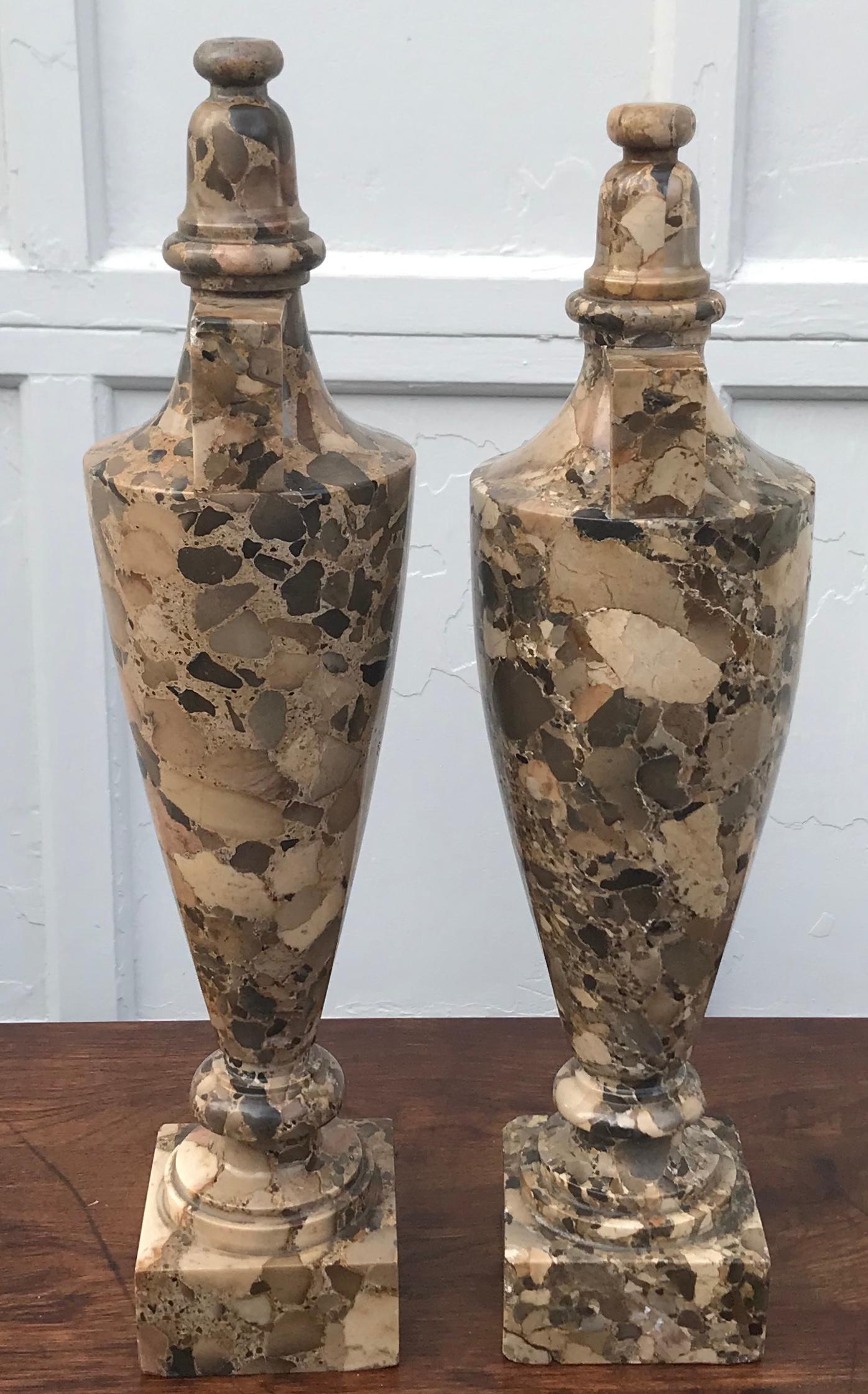 Pair of Breccia marble Amphora urns. Near pair urns in rich brown and coffee colored Italian Breccias marble urn of the Charles X period with black and grey highlights fashioned in a modernistic Amphora style with angled handles capped by an