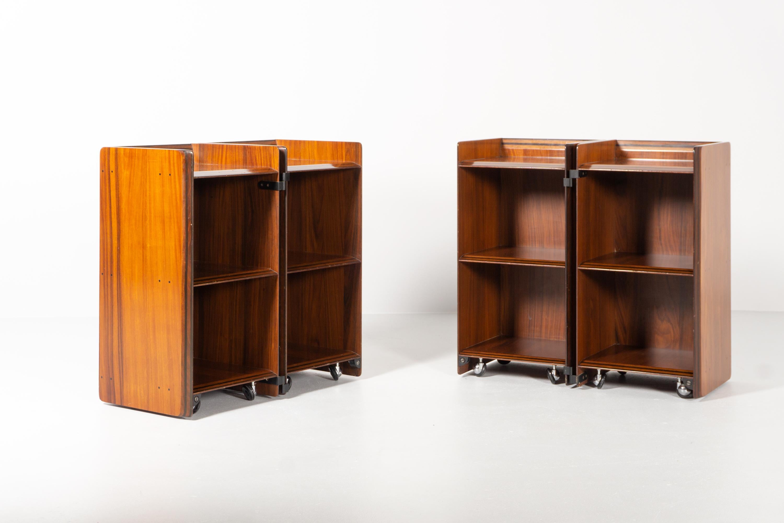 These two hinged cabinets on casters, designed 1975 by Afra & Tobia Scarpa 1975, captivate with their minimalist design and traditional craftsmanship. 
The pieces are exceptionally fine and strongly detailed. 
Tobia and his wife Afra Scarpa worked
