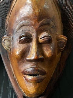 Two Carved Wood African Mask With Gilded Eyelids and Lips and Brass Decorations