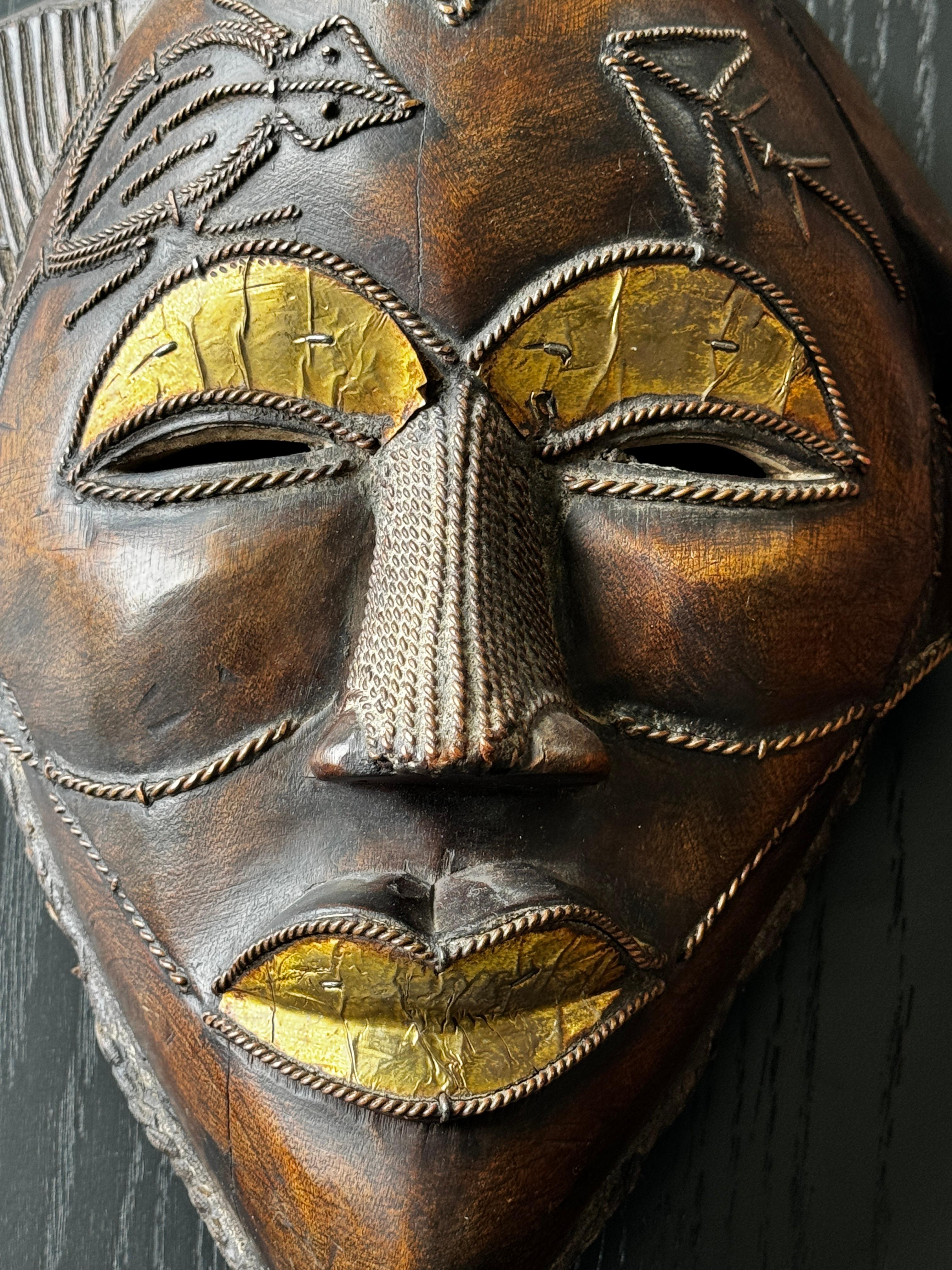 Two Carved Wood African Mask With Gilded Eyelids and Lips and Brass Decorations In Good Condition For Sale In San Francisco, CA