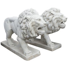 Two Cast Cement or Concrete Walking Lions