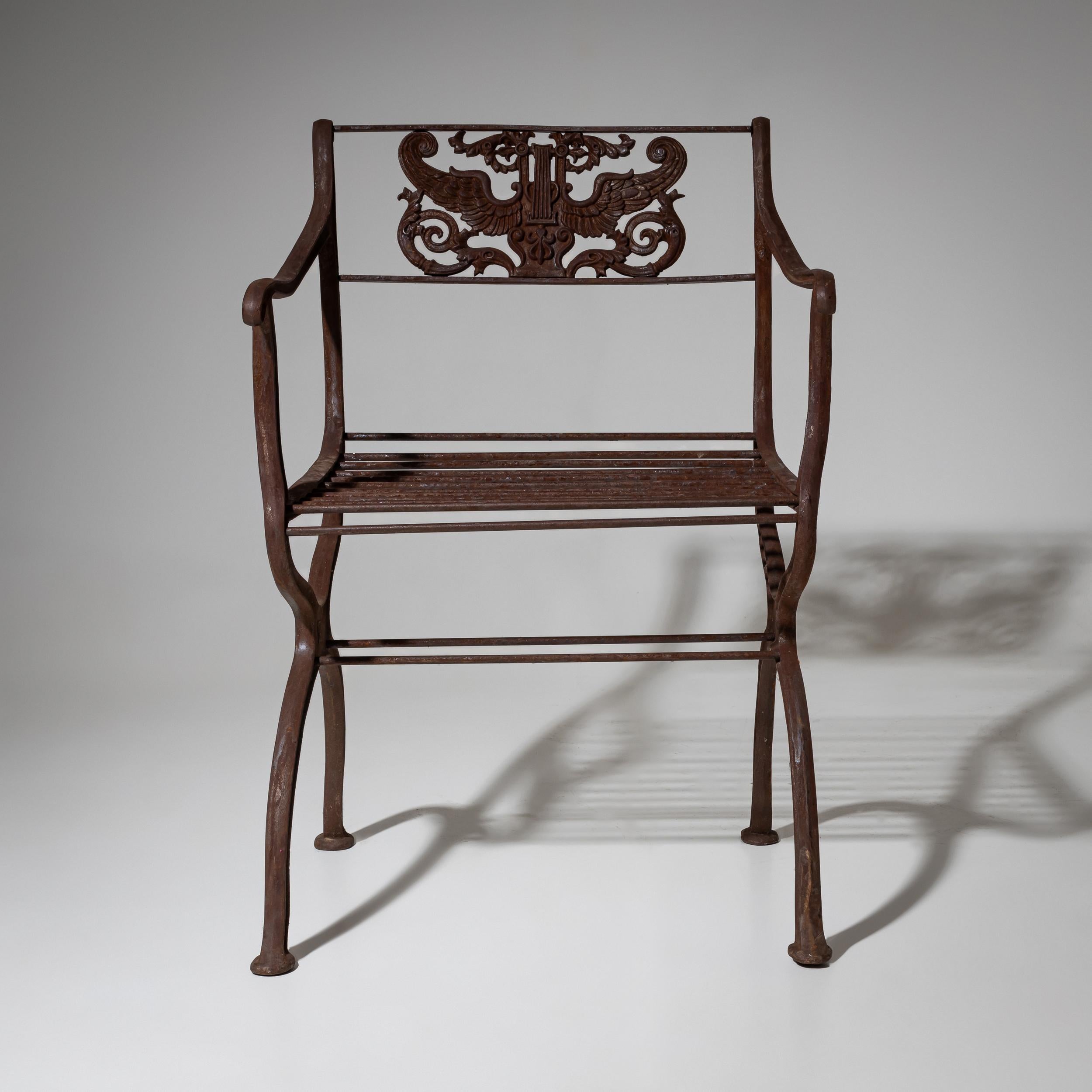 Two cast iron garden chairs based on a design by Karl Friedrich Schinkel, created around 1830 for the Roman Baths in Potsdam. These armchairs are later reproductions by the Lauchhammer art foundry, stamped LR, likely from the 20th century. One chair