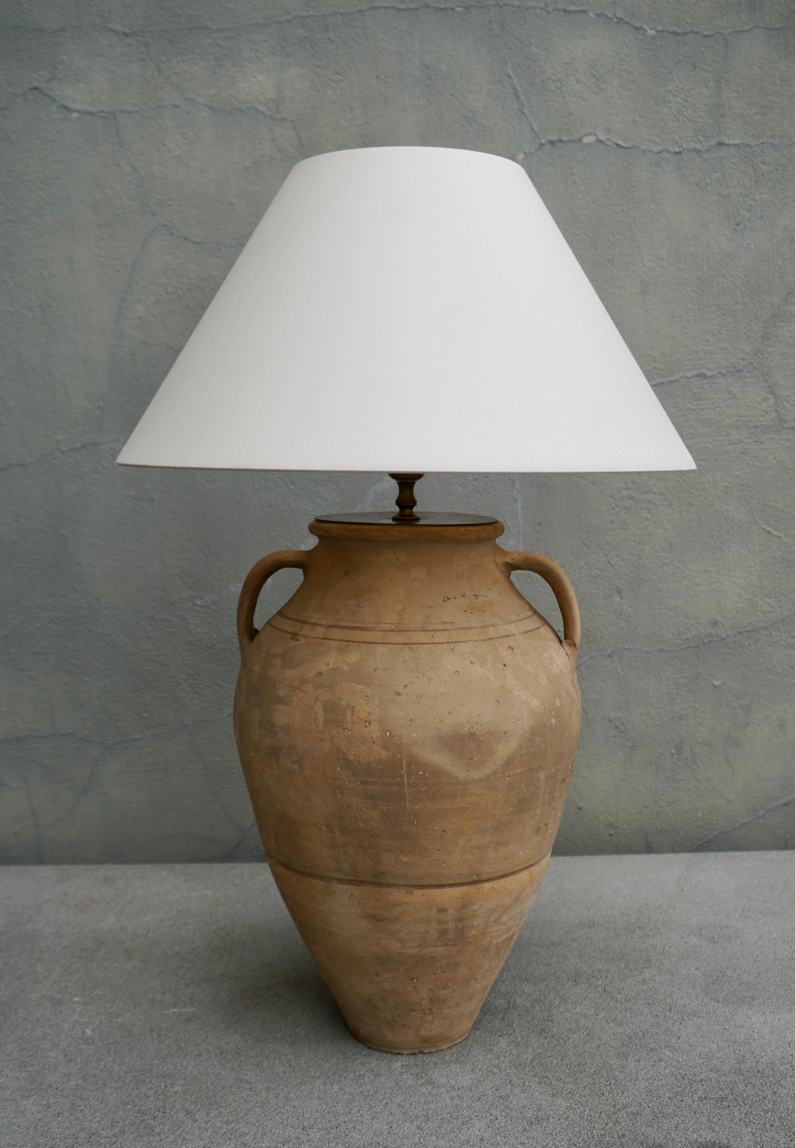 These amazing custom made living room lamps are made out of antique urns. Beautiful patina throughout the lamp and stems. Very chic. 

Height with shade 28.7