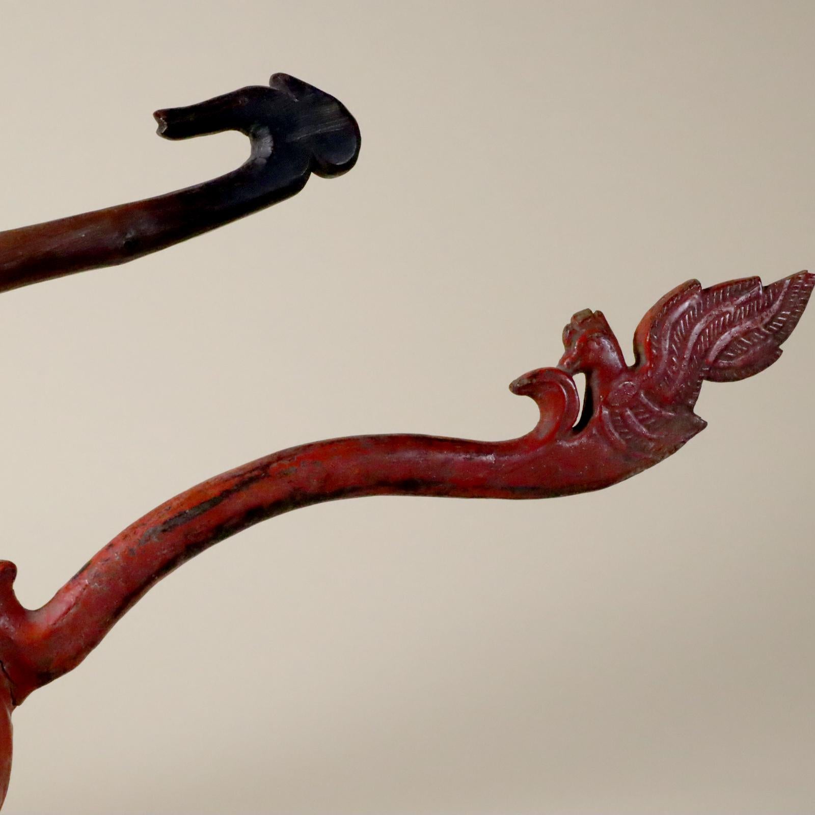 Store closing March 31.. Last chance clearance sale.  Two ceremonial holy water dippers. Wood handle terminating in a bird head and a complete bird (on the red one) and coconut bowl. One with red lacquer. The other unpainted, with rubbed and