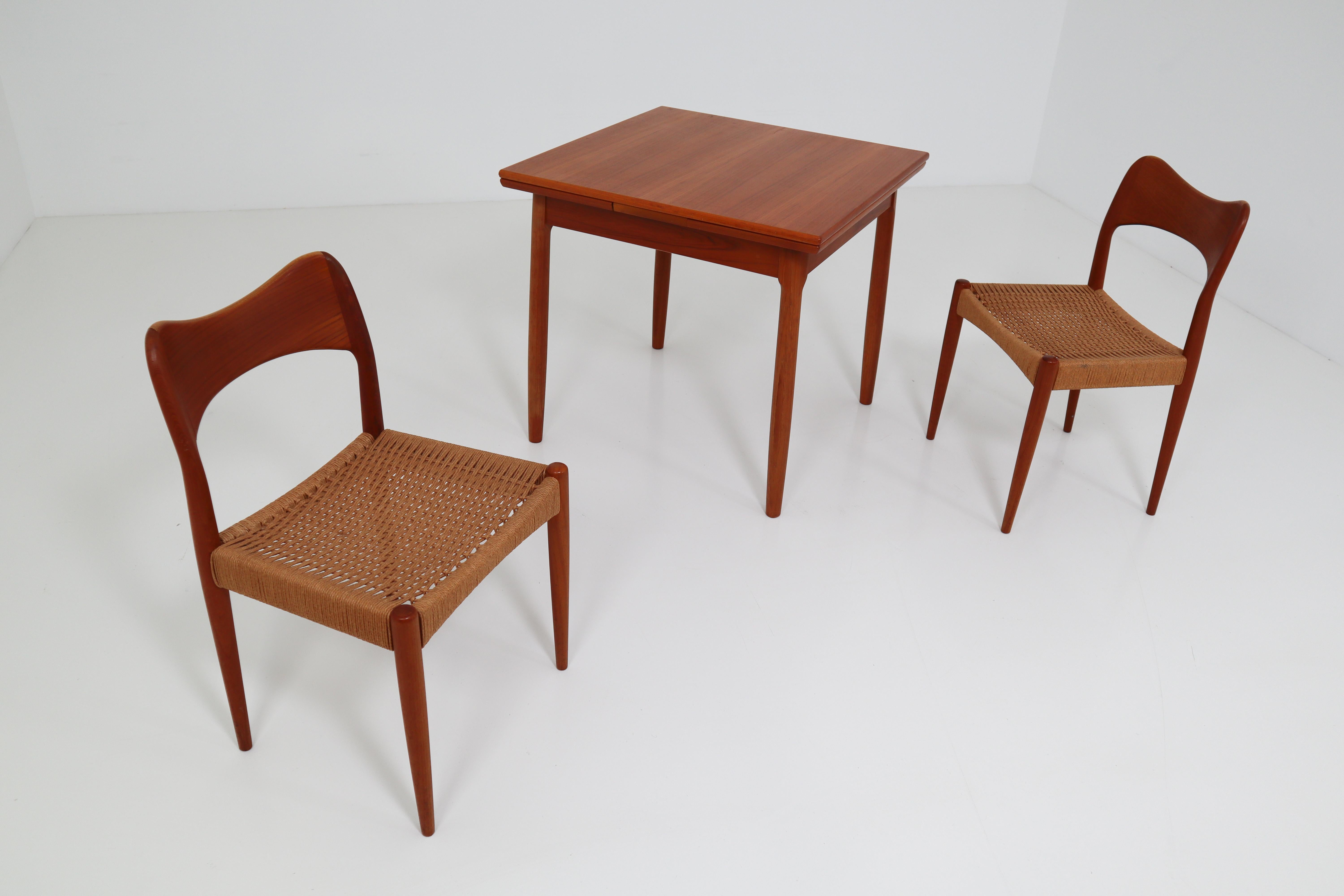 Designed in 1951 by Niels Otto Møller for J. L. Møllers Møbelfabrik, these Classic Danish dining chairs, model 71, feature graceful teak frames and handwoven papercord seats. Small model 12 teak dining table by Niels O. Møller. Excellent condition.