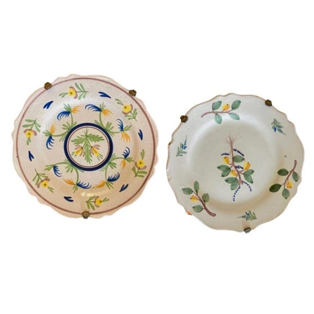 Two charming 18th Century French Faience plates , yellow, blue, and green floral and foliate ,w/early claw hangers. 1.25” h. x 9.5” diam.