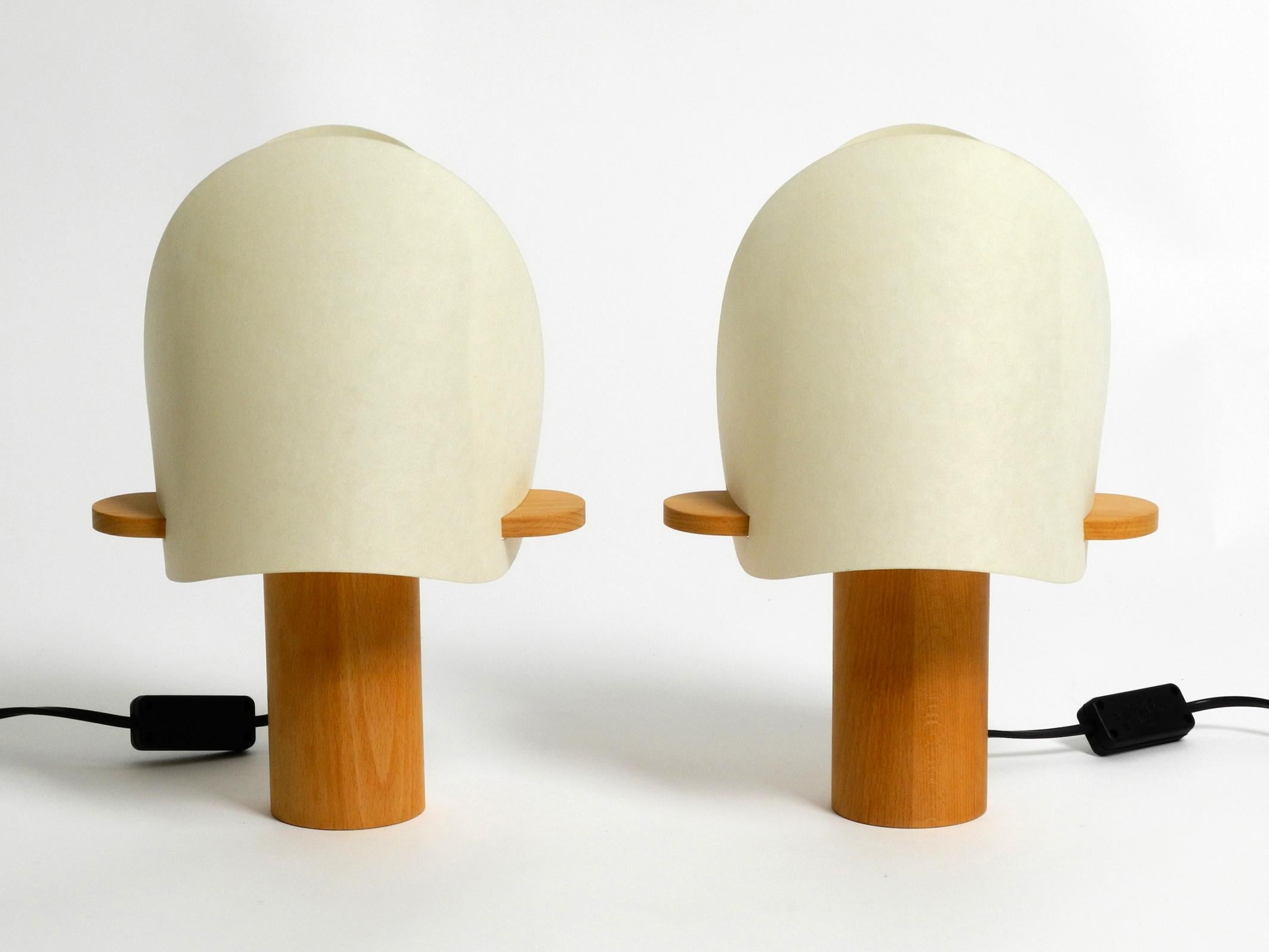 Two charming minimalist oak wood table lamps with Lunopal shades.
Great minimalist Postmodern design from the 80s.
With original label on the bottom. Type 7317. Made in Germany.
These table lamps are no longer produced by Domus.
The shade is
