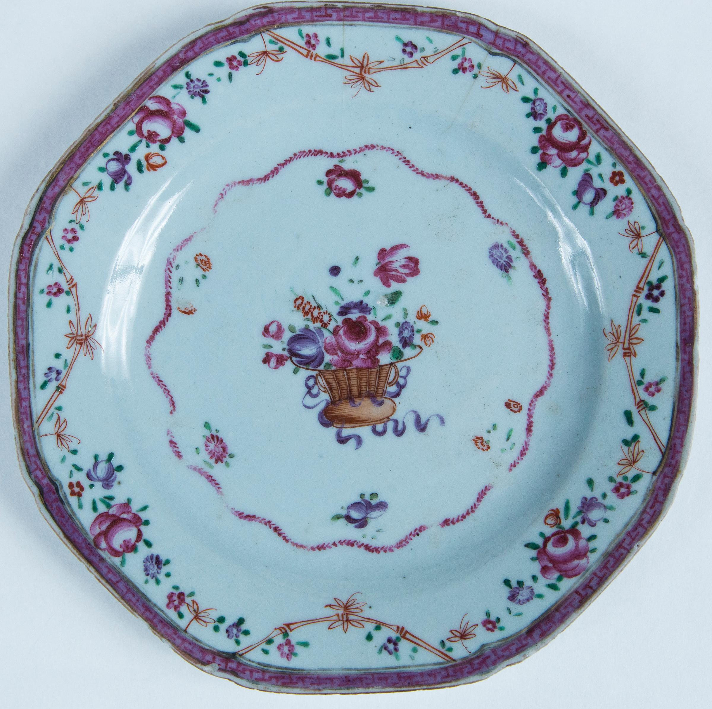 Two Chinese Export porcelain plates, Early 19th Century. Hand-painted polychrome floral designs with detailed borders.