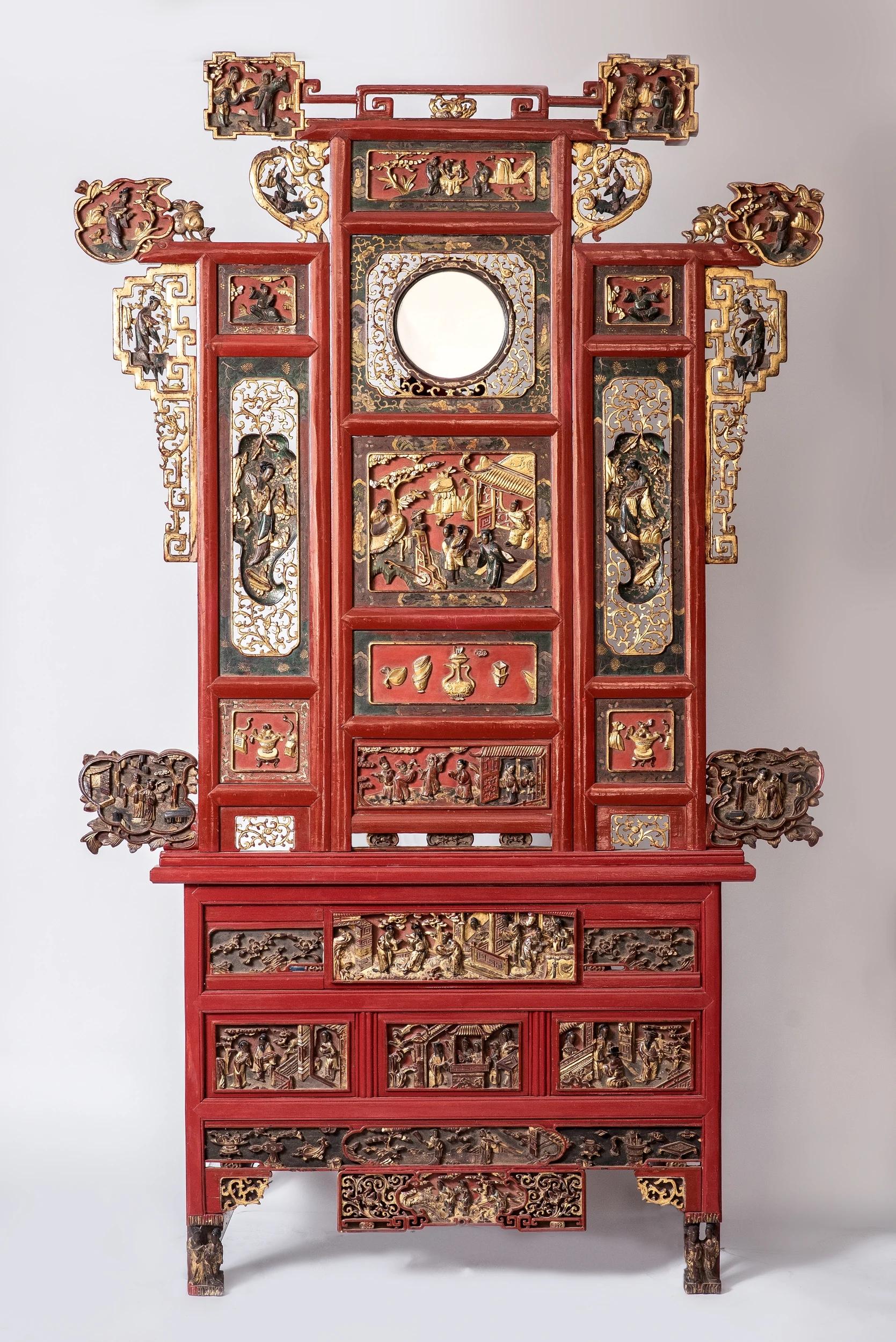 Two large panels of a Chinese wedding bed, richly carved with figures, festive scenes, gifts and symbols of prosperity.
Carved wood, red lacquer, gold leaf and black lacquer. China, late 19th century.

The two panels are not quite the same