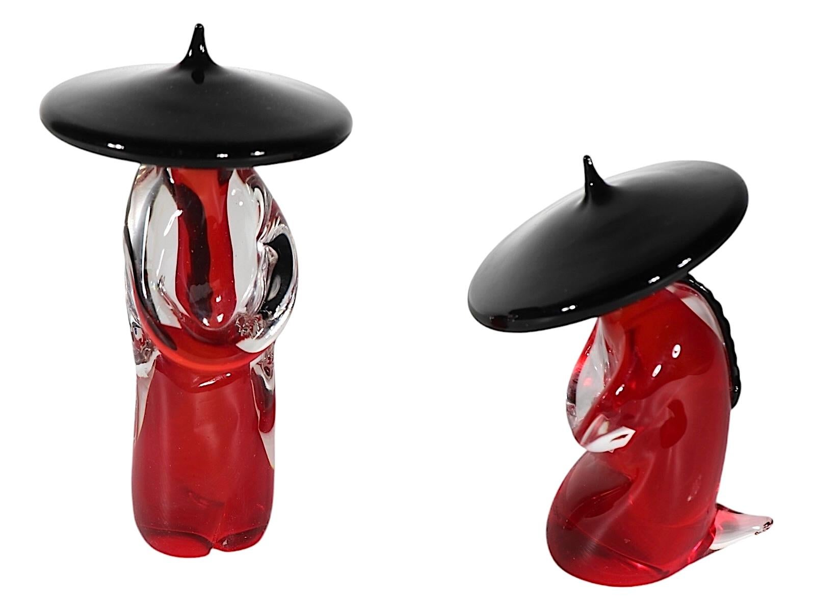 Stunning lot of two Asian style figures, executed in bold red, clear and black glass using the classic Sommerso technique. Both figures are in excellent, clean, ready to display condition, free of damage or repairs.  Often attributed to Seguso, we