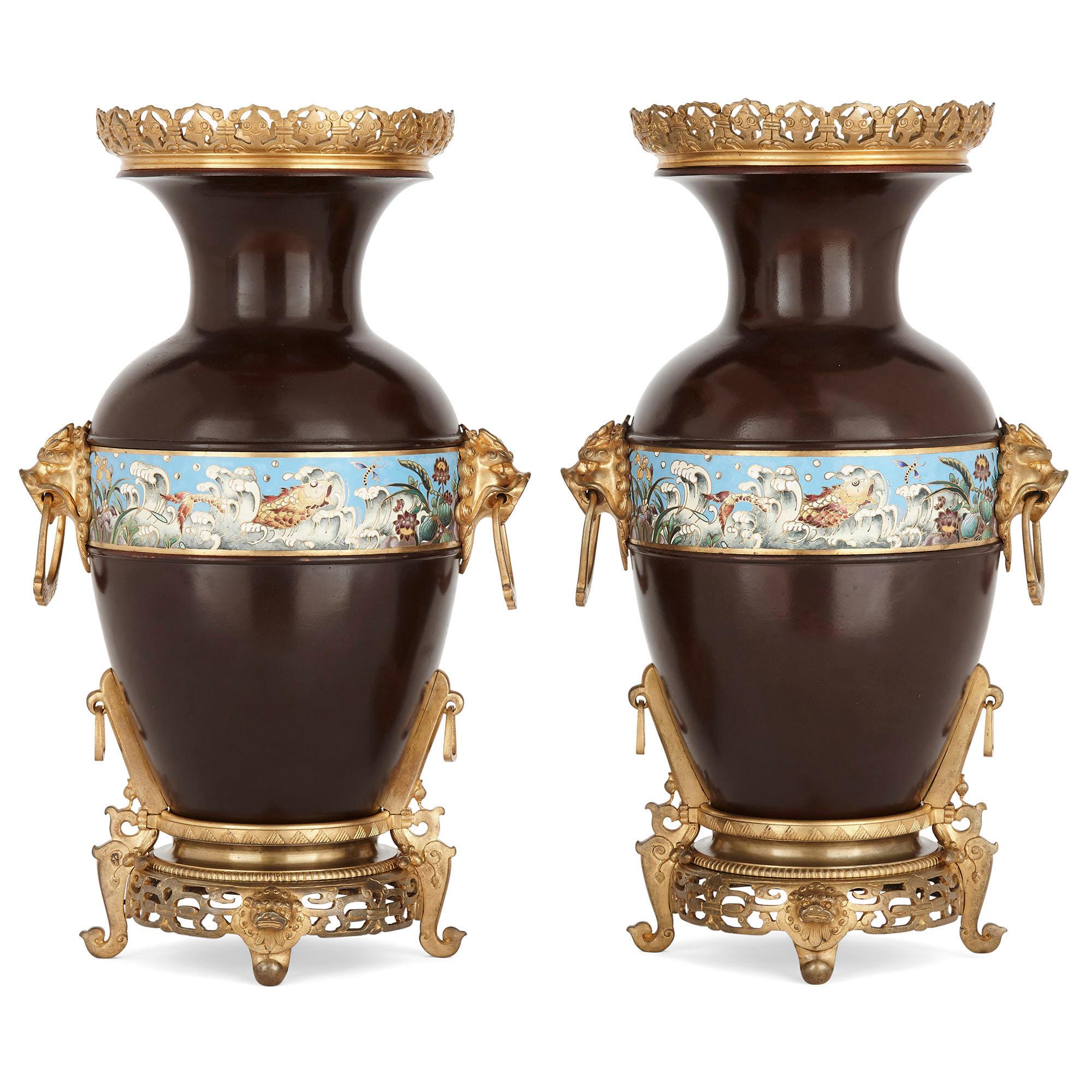 Two Chinese style enameled gilt and patinated bronze urns
French, circa 1880
Measures: Height 44.5cm, width 27cm, depth 20cm

Each urn, or vase, is of typical form with bulbous body leading to a narrow neck with outward flaring circular rim. The