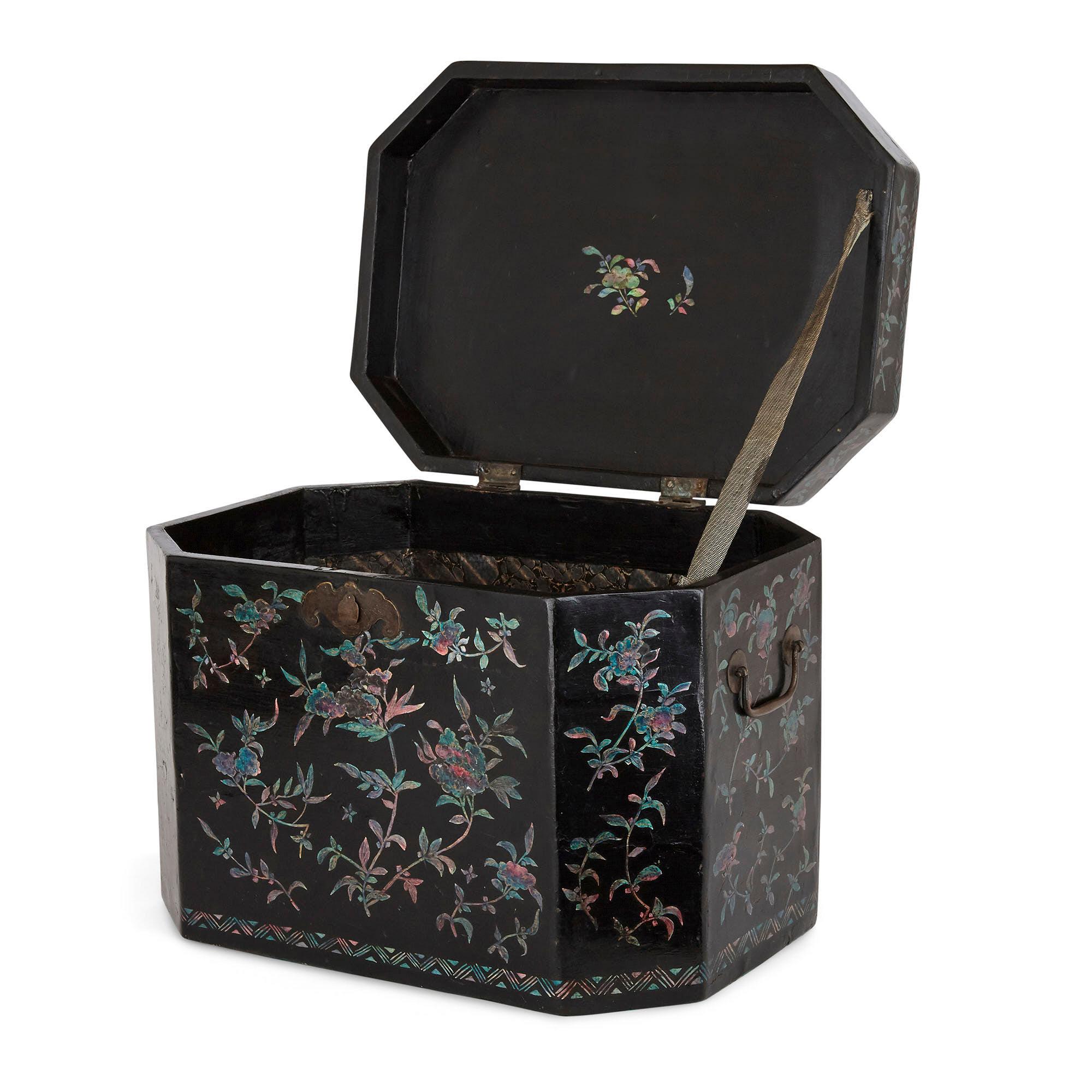 This duo comprises two Chinese work boxes: one, of lacquered and parcel giltwood, was produced circa 1850, while the second, of painted wood inlaid with ersatz mother of pearl, dates to the early 20th century. The boxes feature hinged lids and
