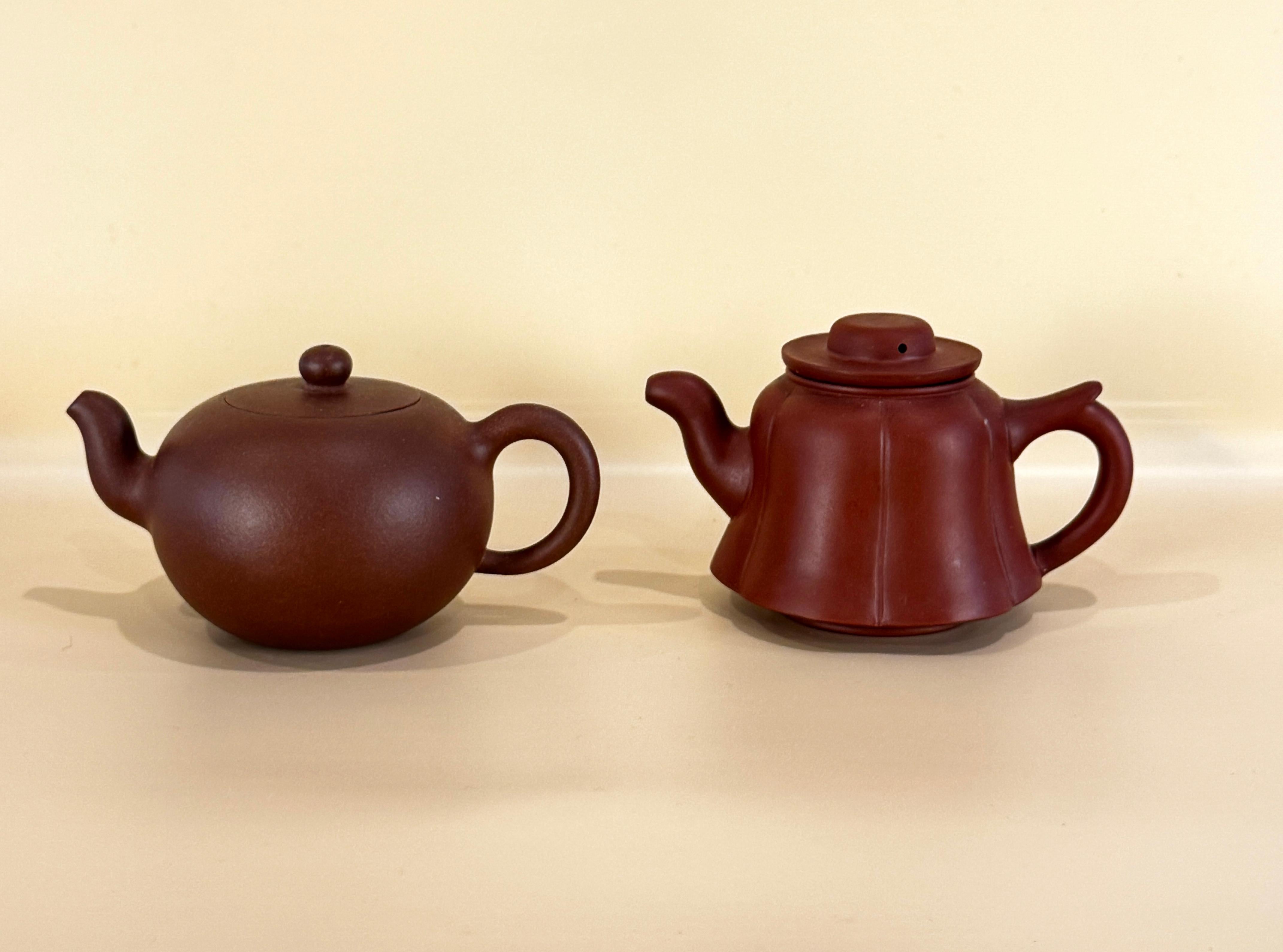 Three Chinese Yixing Clay Teapots, probably 20th Century. These charming teapots are beautifully formed of clay and varying in rich shades of brown. The taller has a fluted body, the shorter is of rounded form. The teapots are elegant in their
