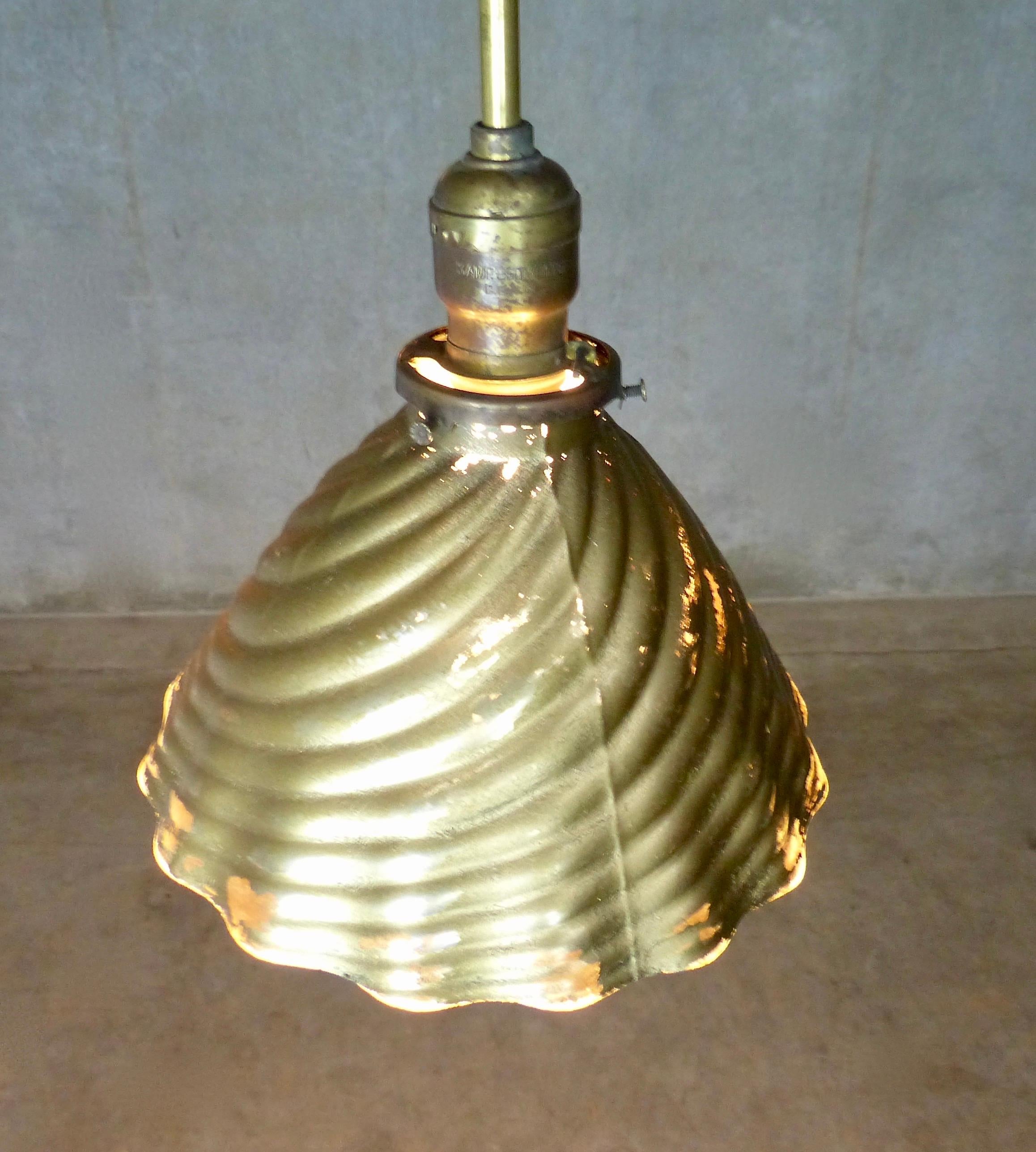 Matched pair of mercury/X-ray pendant lights from circa 1930. Deeply grooved surface texture with largely intact gold-tone exterior and silver/mercury interior. Re-wired and CSA approved to current electric standards; ceiling mounting plates