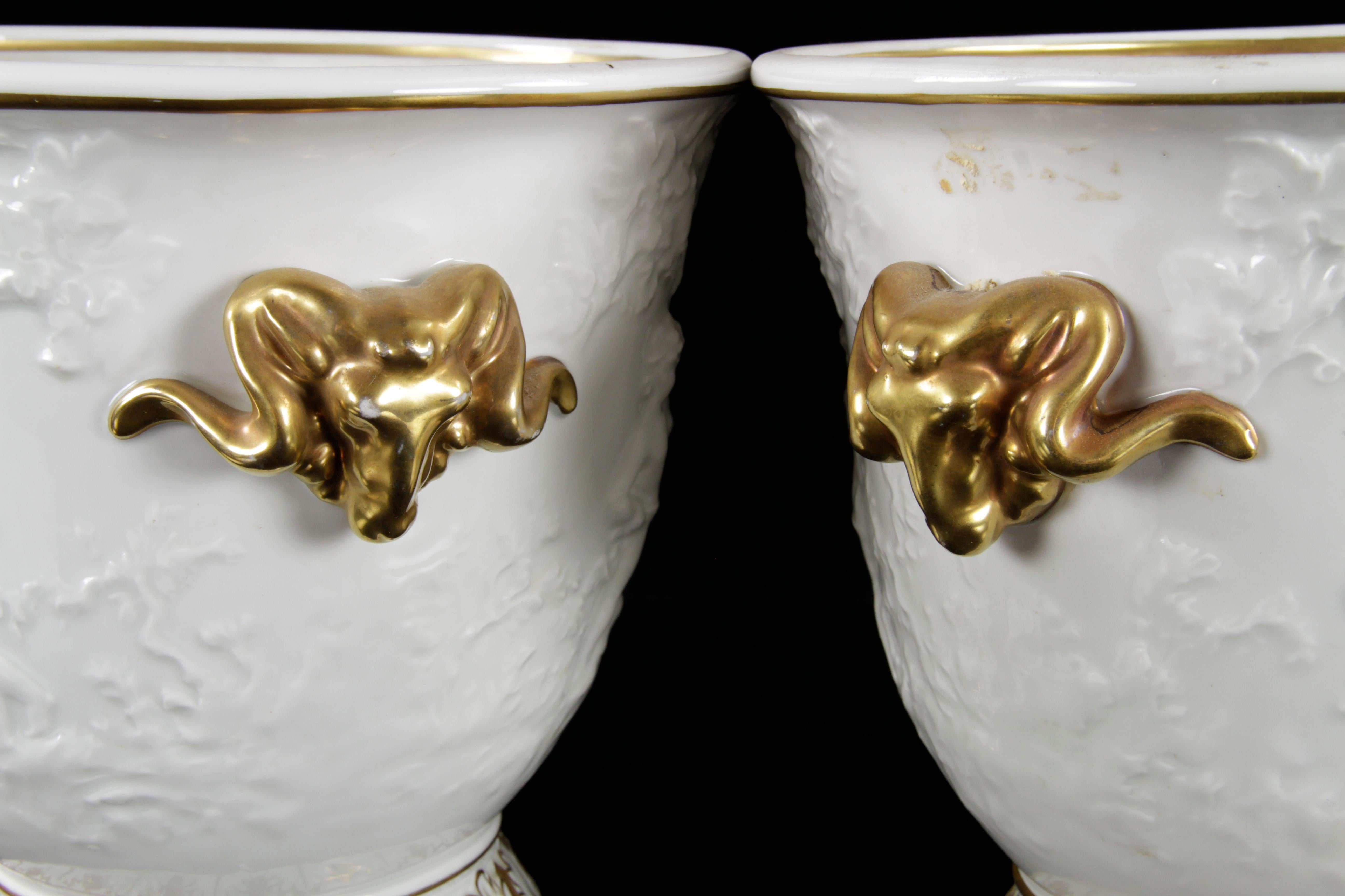 Two classical Capodimonte cache pots white porcelain with cherubs and gilt decoration.