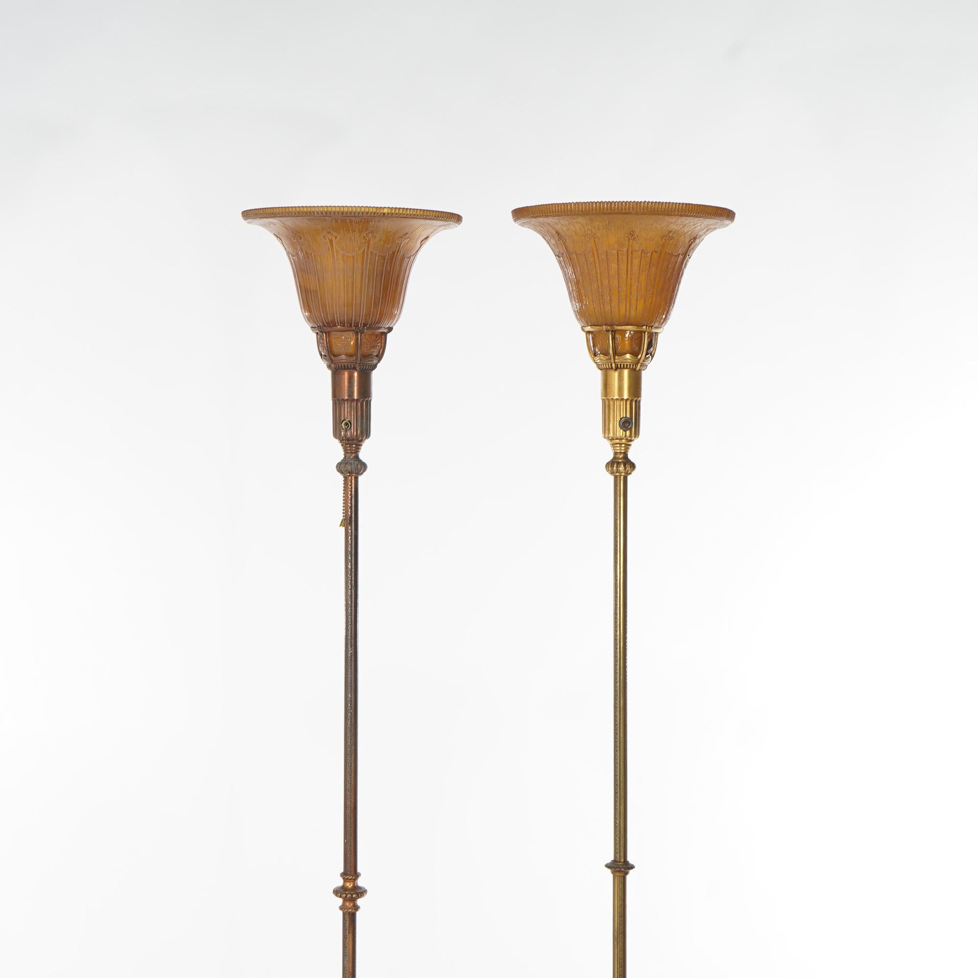 Cast Two Classical Torchiere Gilt Metal & Amber Glass Floor Lamps by Lightolier