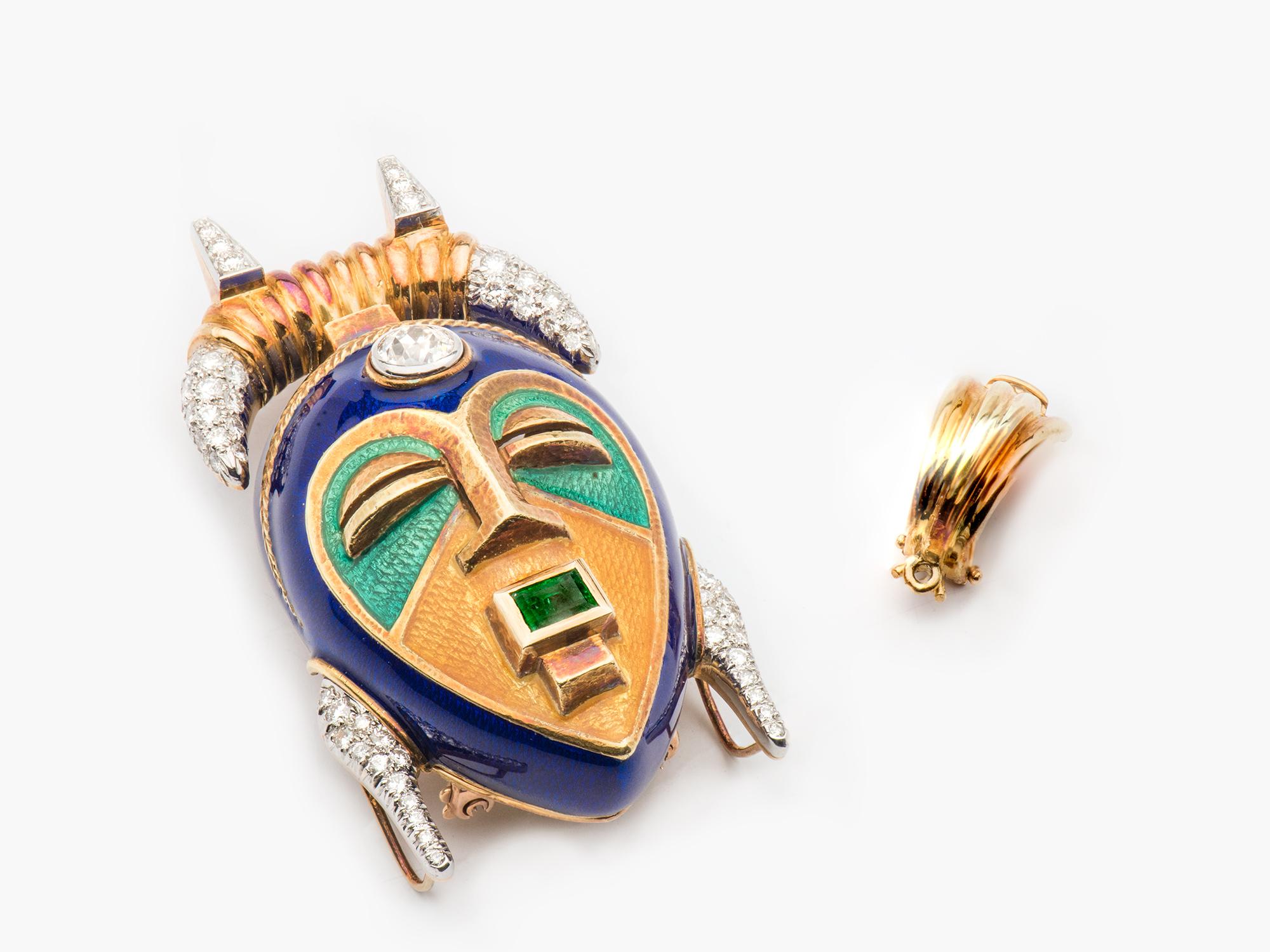 Two Color 18k yellow and white gold Enamel Mask Pendant Clip Brooch with approximately 2 cts of Diamonds and Emerald accents. The bezel is 1/2