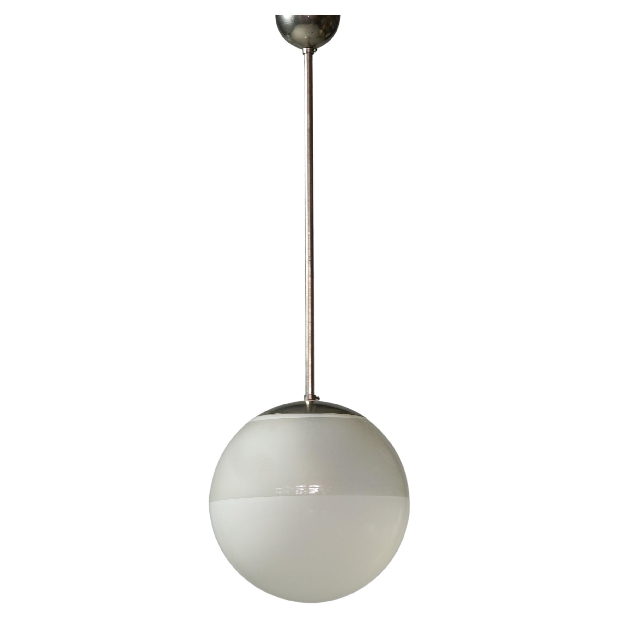 Two colored glass and chromed metal pendant, designed by Paavo Tynell, 1930/1940s. Good vintage condition, minor patina consistent with age and use. Beautiful minimalistic Scandinavian Modern design. 

Paavo Tynell (1890-1973) is one of the most