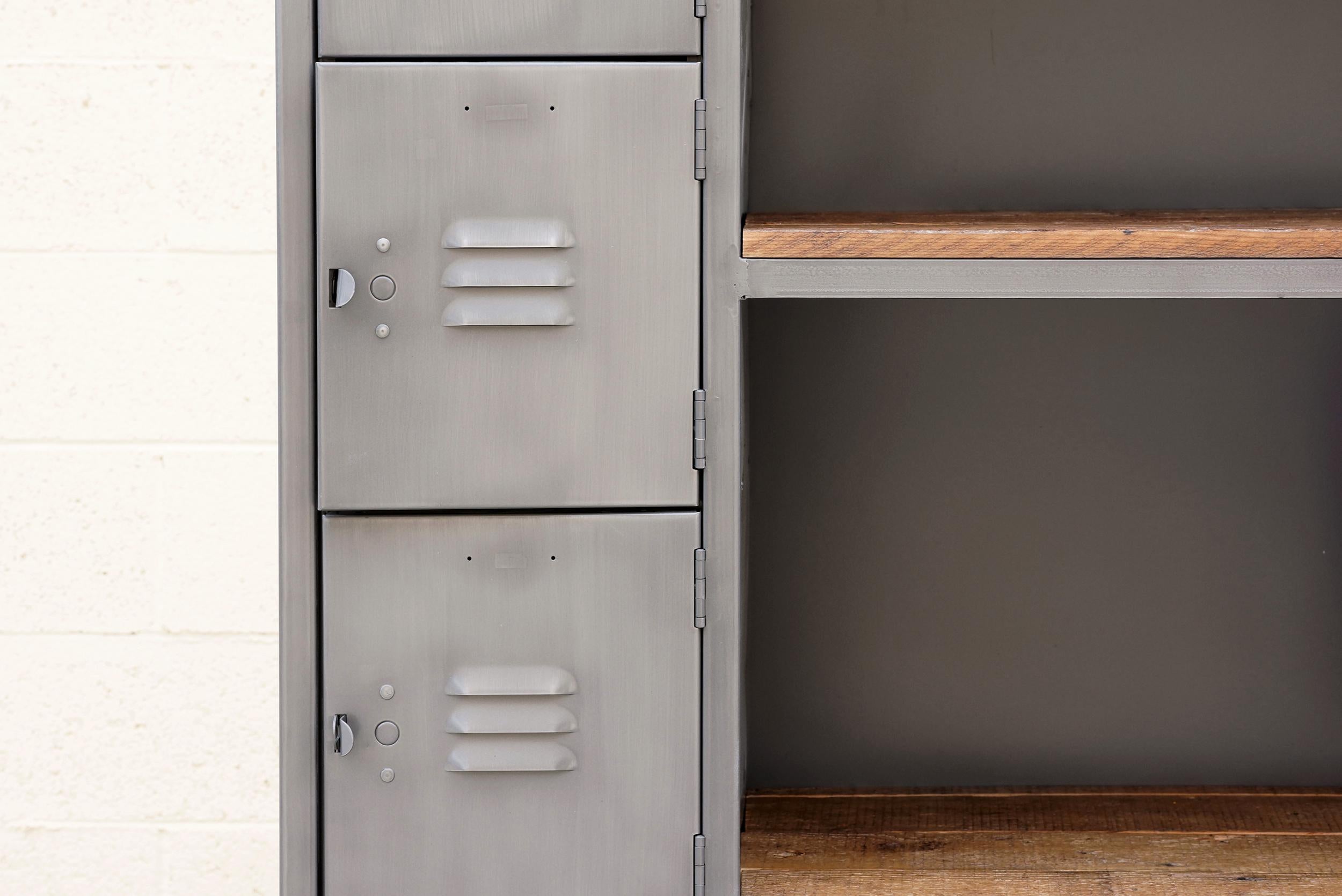 Our two-column cubby locker and shelf unit is a winner! Composed of a custom built steel frame and refinished vintage lockers powder-coated in Natural Steel; paired with reclaimed barn-wood shelves. Features 12 lockable cubbies and four shelves.