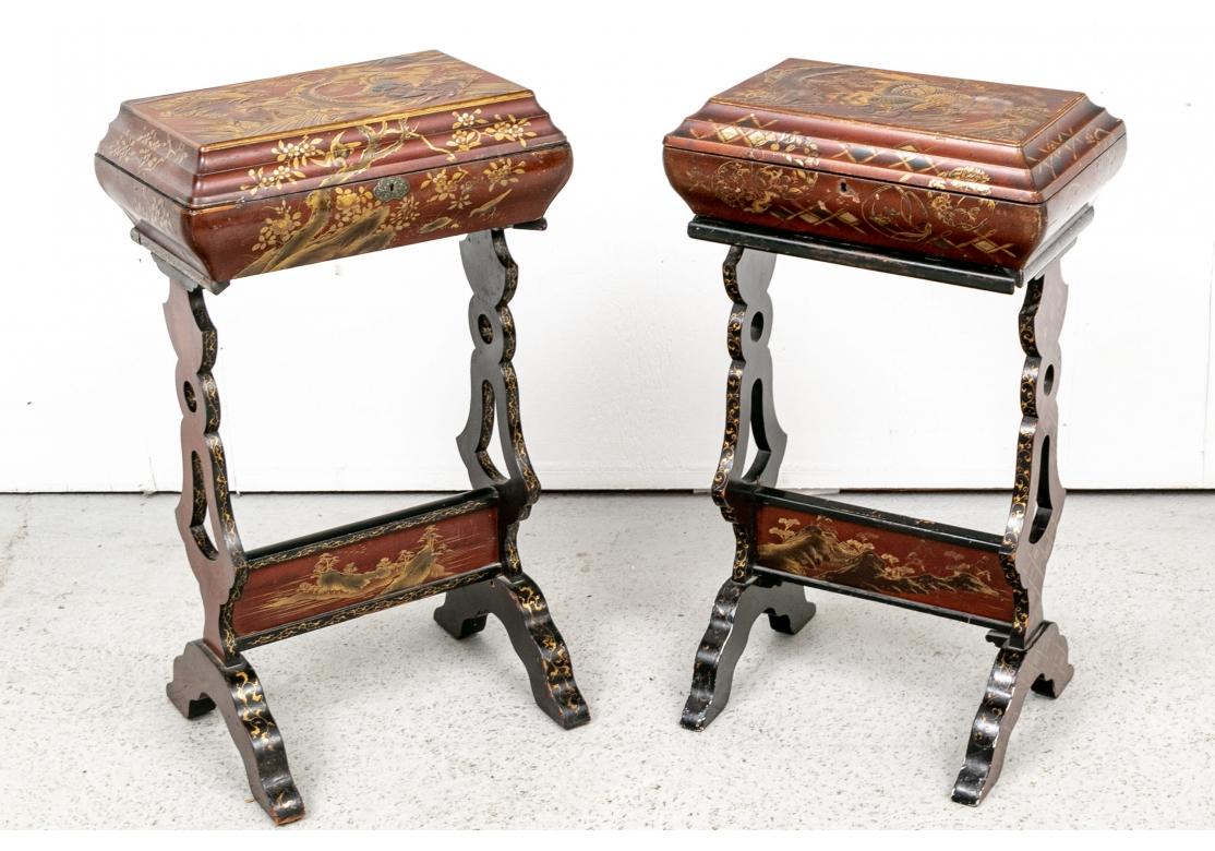 A decorative and colorful compatible pair of Japanese Calligraphy Stands in gilt and lacquer decoration. The red lift tops with elaborate lacquered and gilt decoration of birds and snakes in landscapes. Fine black lacquered and gilt interiors with a