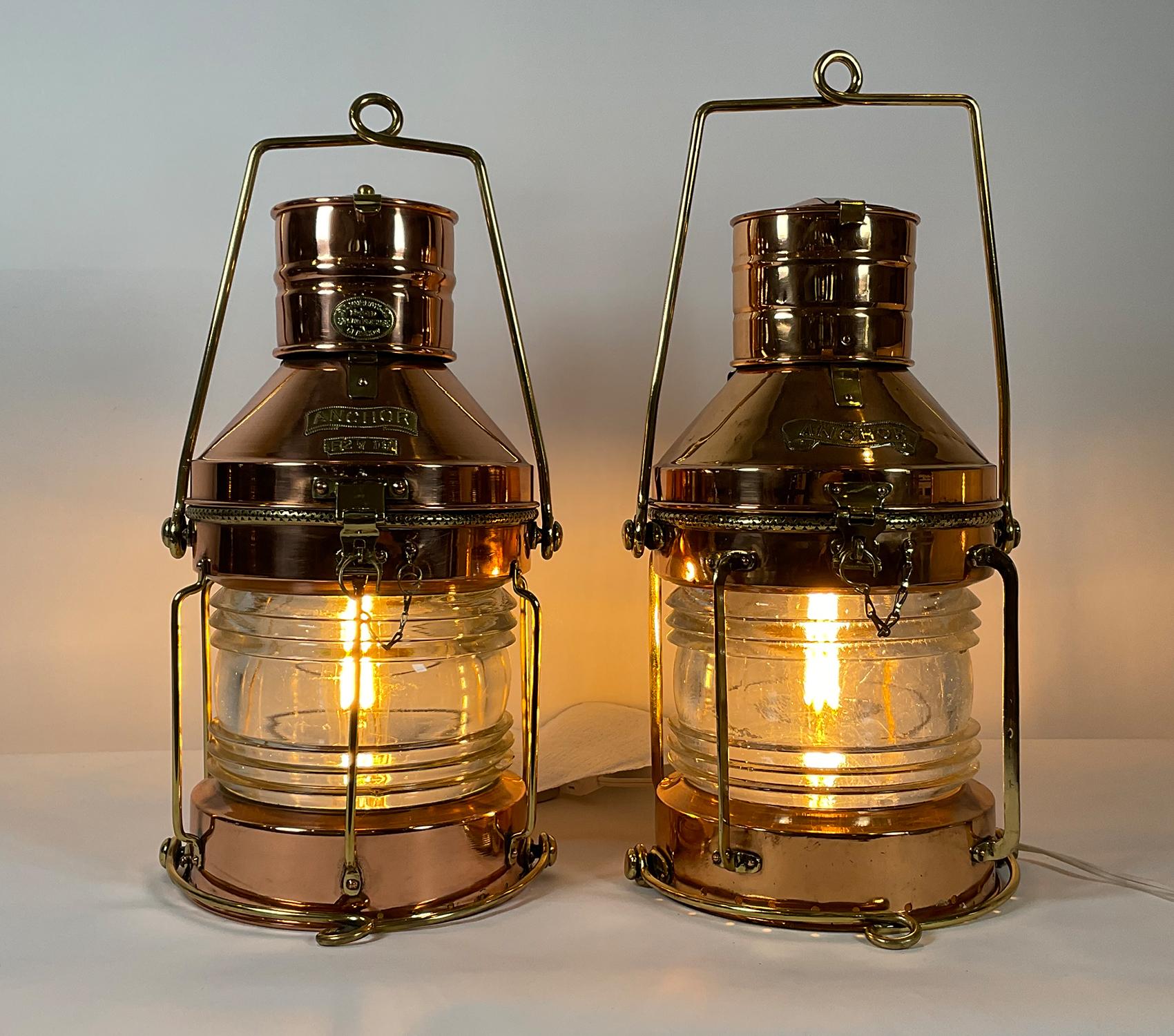 Here are two outstanding ship’s anchor lanterns. They are not a perfect “pair” but they are very closely matched. Both are antique ship’s lanterns with copper housings, brass trim, brass “anchor” badges, one with badge from R.C. Murray Limited, 37