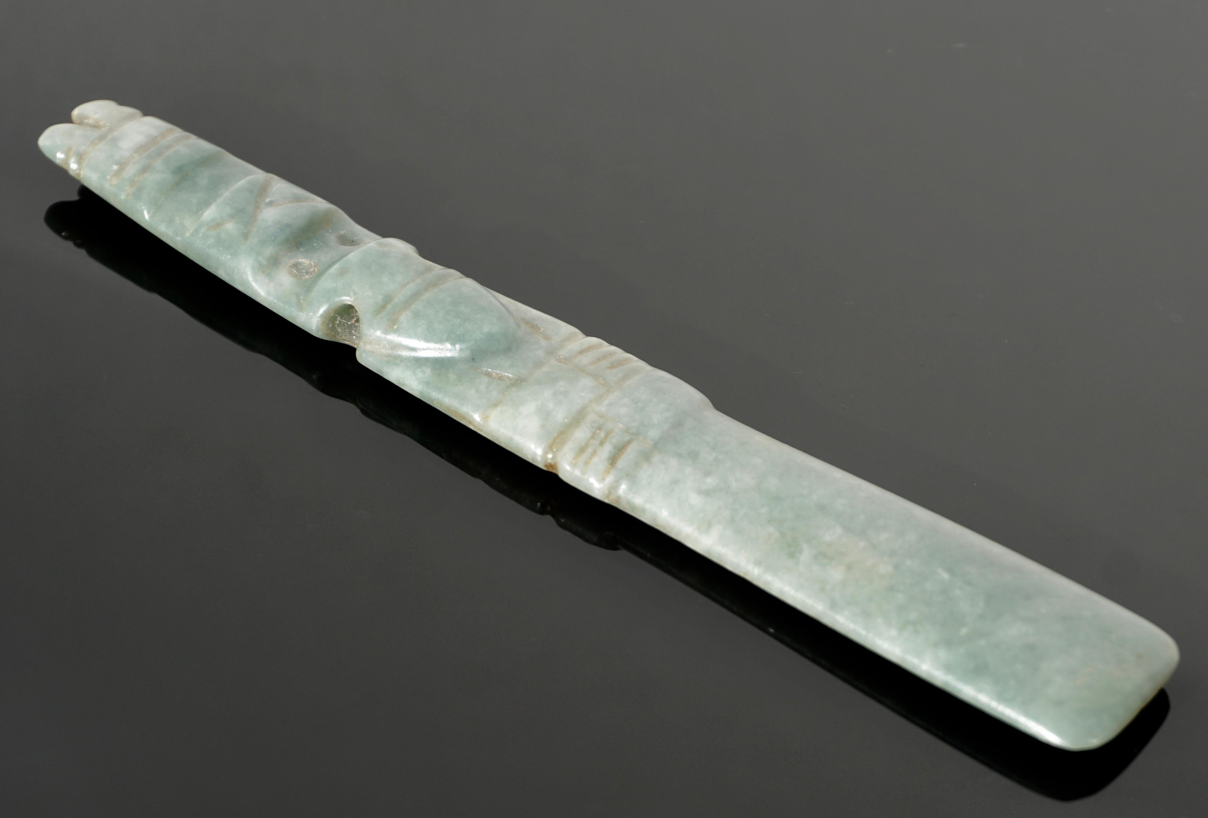 Un Dios del Hacha de Jade costarricense.
Región de Guanacaste-Nicoya, circa D. A. 1-1500 

De forma de celta que representa la figura mítica en parte humana y en parte aviar, con ojos circulares que asoman de la máscara de ave, el pico con carúncula