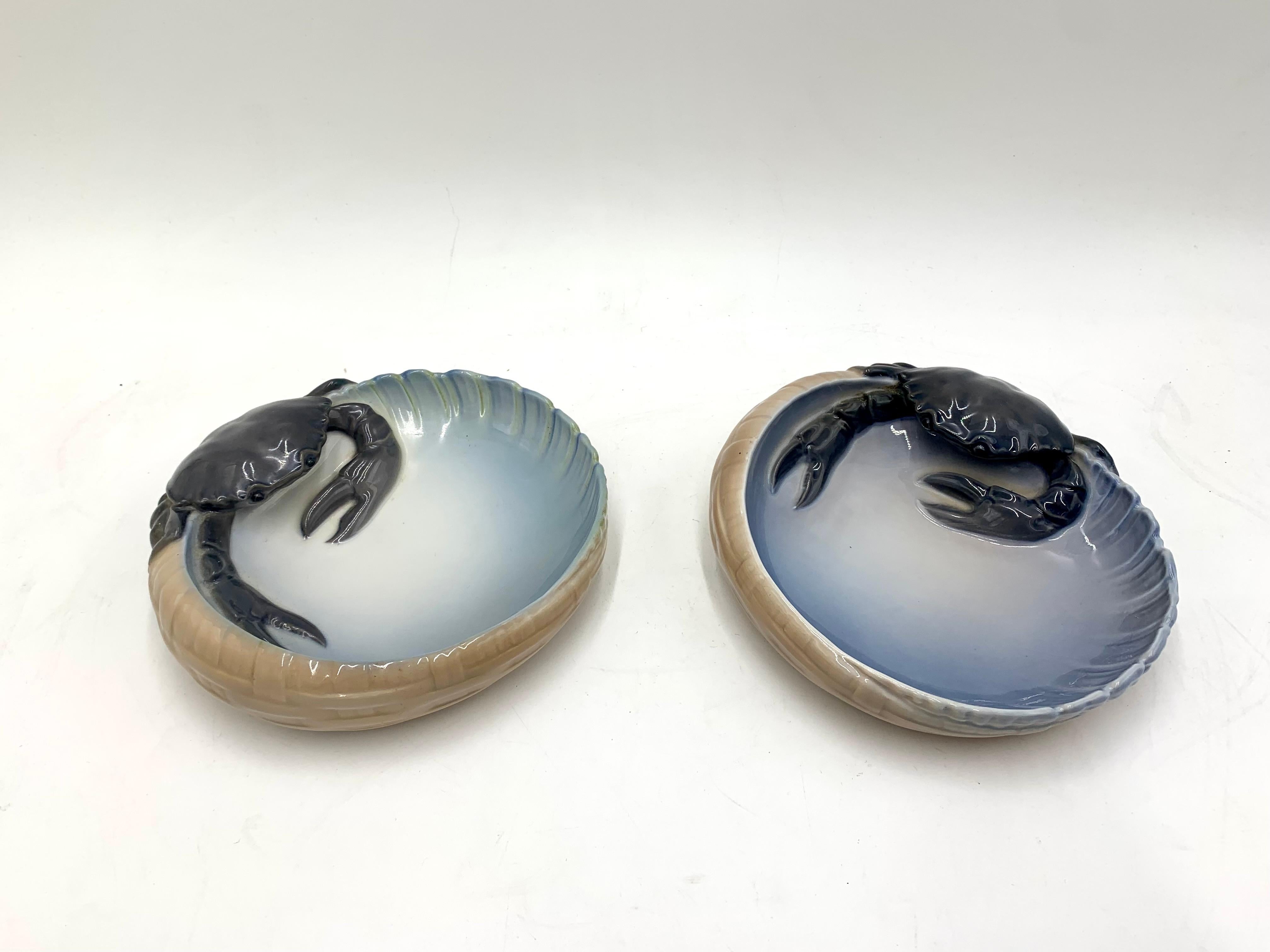 Two decorative crab-themed plates for seafood or snacks.

Plates manufactured in Denmark in the 1950s by the Royal Copenhagen manufactory.

Signed with the royal crown, Royal Copenhagen signature. Formula number # 3131

Very good condition, no