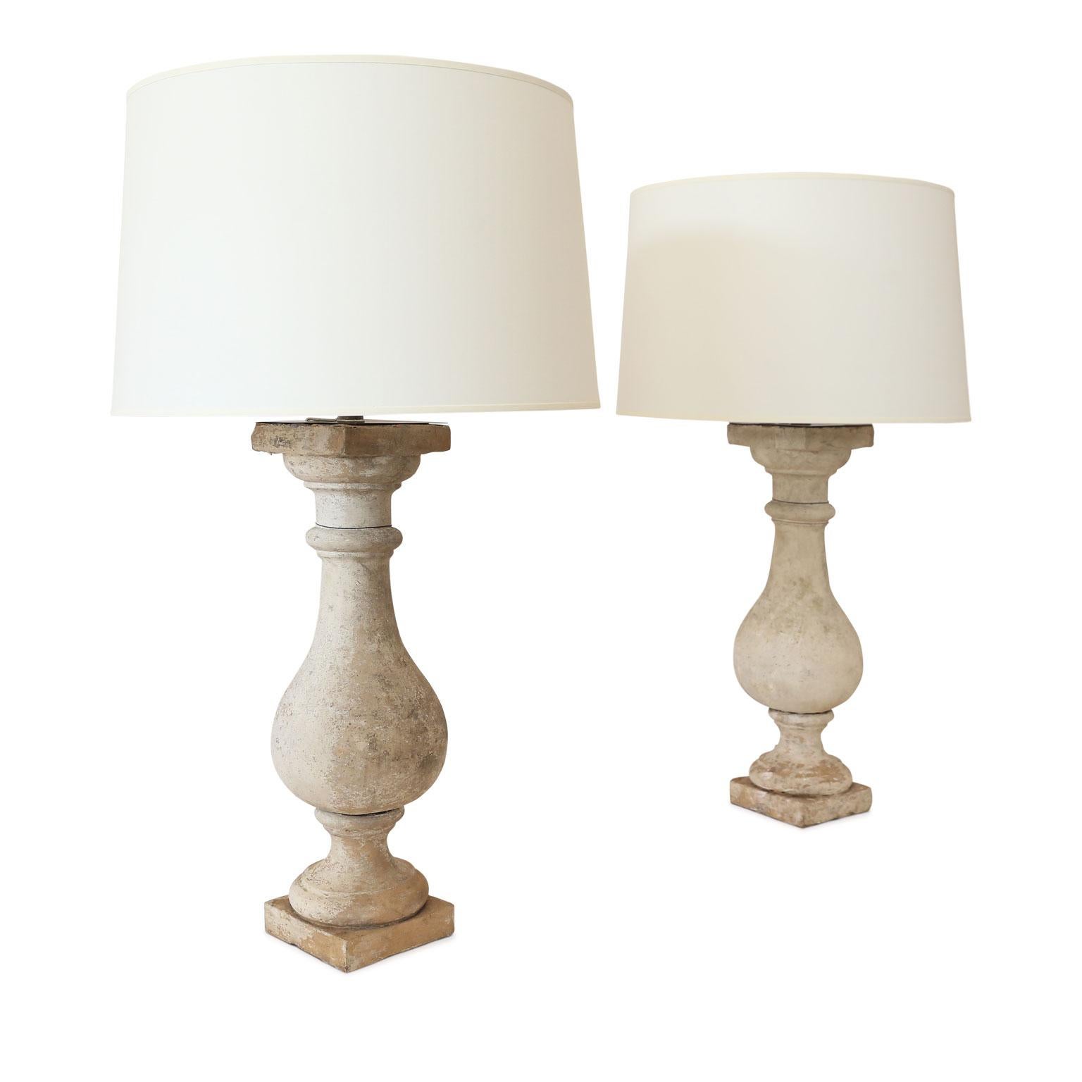 Two custom terracotta lamps from antique terracotta balusters, newly-wired for use within the USA. Complementary fabric hard-back drum shades included (measurements include shades).