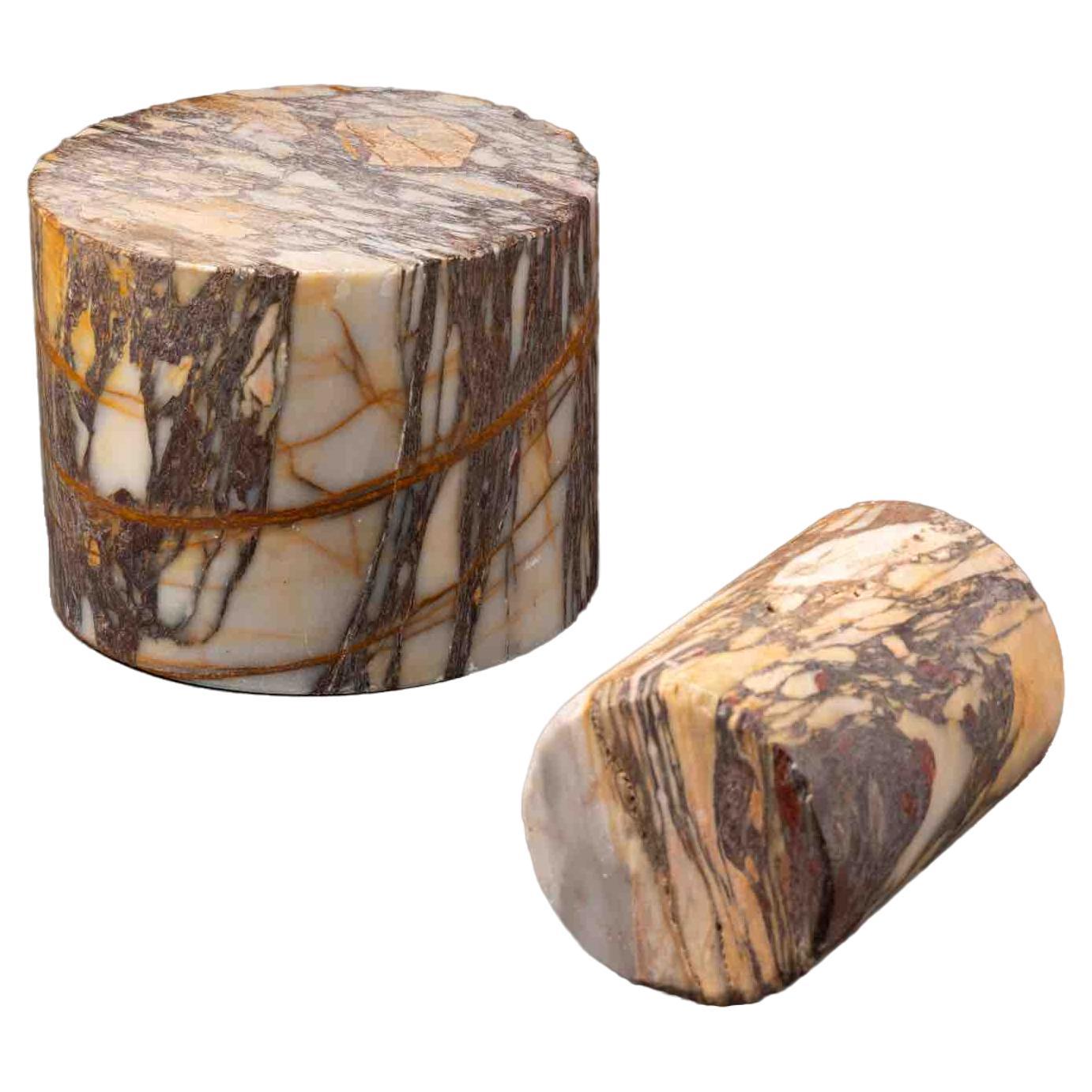Two cylindrical colored marble specimens