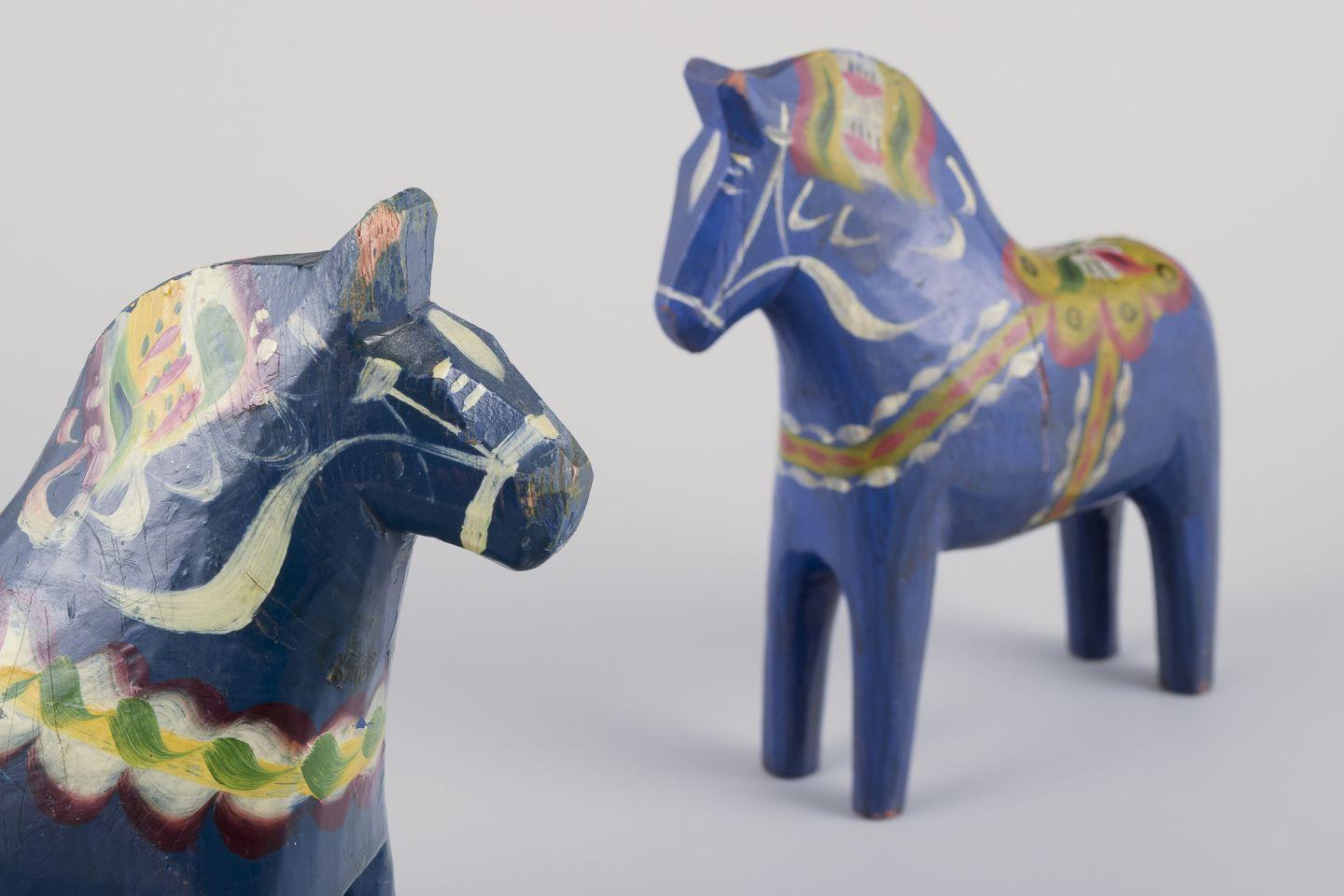 Two Dala horses. Hand-painted with floral motifs on a blue background. Folk art. For Sale 1