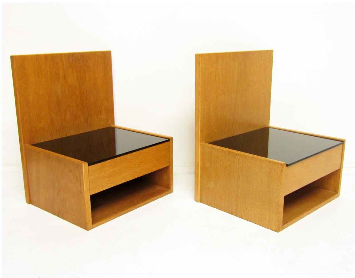 A pair of Minimalist Danish 1960s floating nightstands in oak and black glass by Hans Wegner for GETAMA.

These beautifully understated nightstands can be affixed to a Hans Wegner bed frame, or paired with any bed, suspended with standard wall