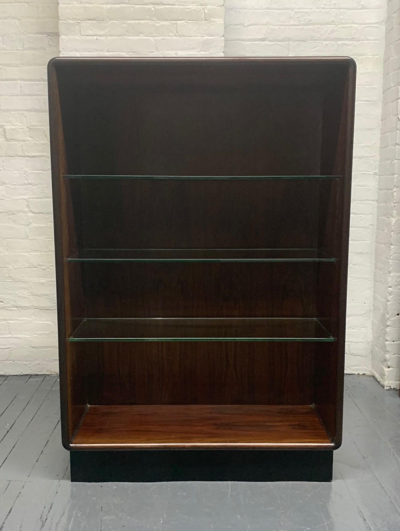Two Danish modern rosewood bookcases. Bookcases have glass adjustable shelves with black lacquered bases. Beautiful rosewood grain.