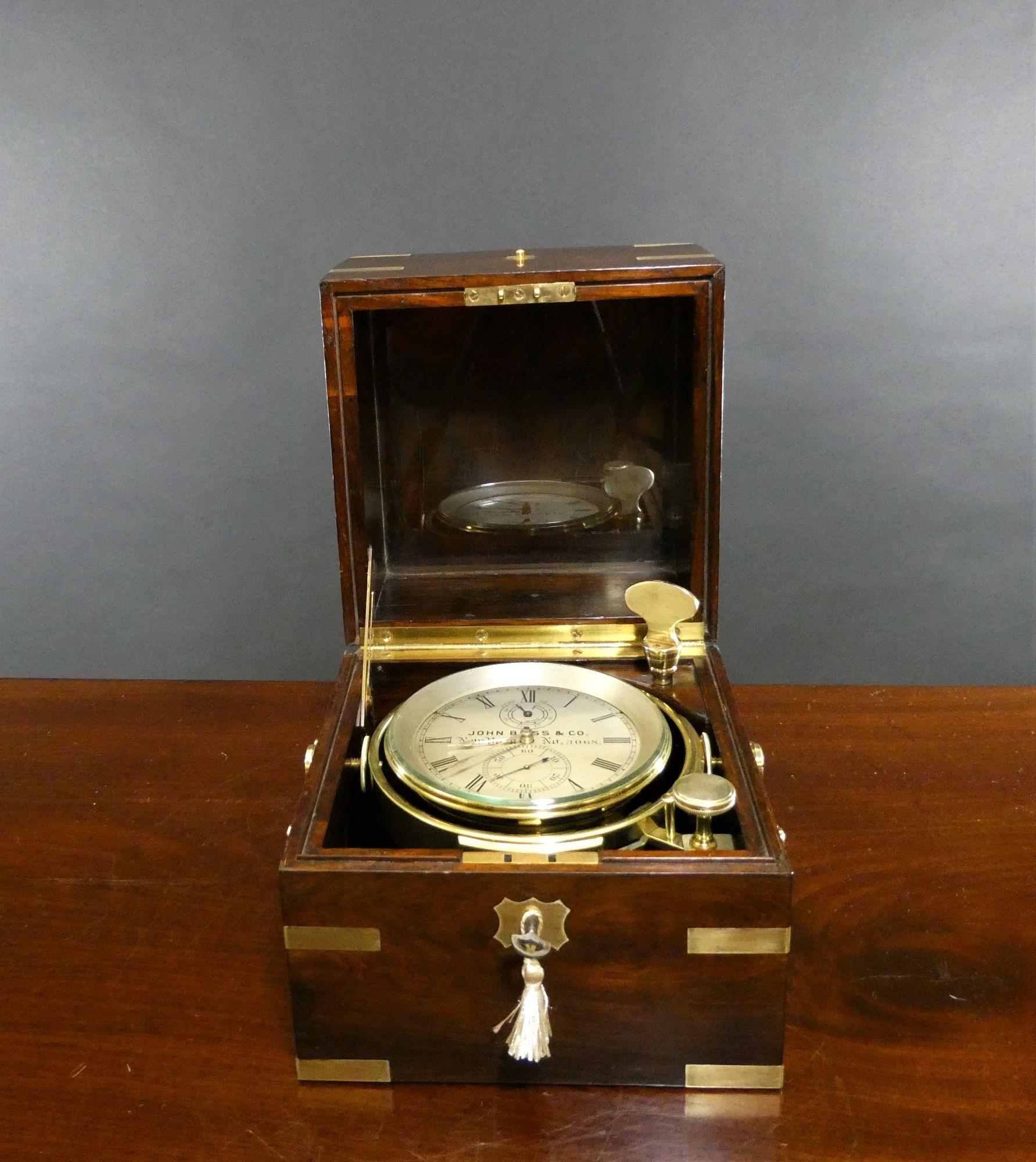 A Fine Two Day Marine Chronometer by John Bliss and Co, New York. No.3068
 
Two day marine chronometer by John Bliss & Co housed in a beautiful three tier rosewood brass bound box with brass carrying handles to the sides, brass push button knob