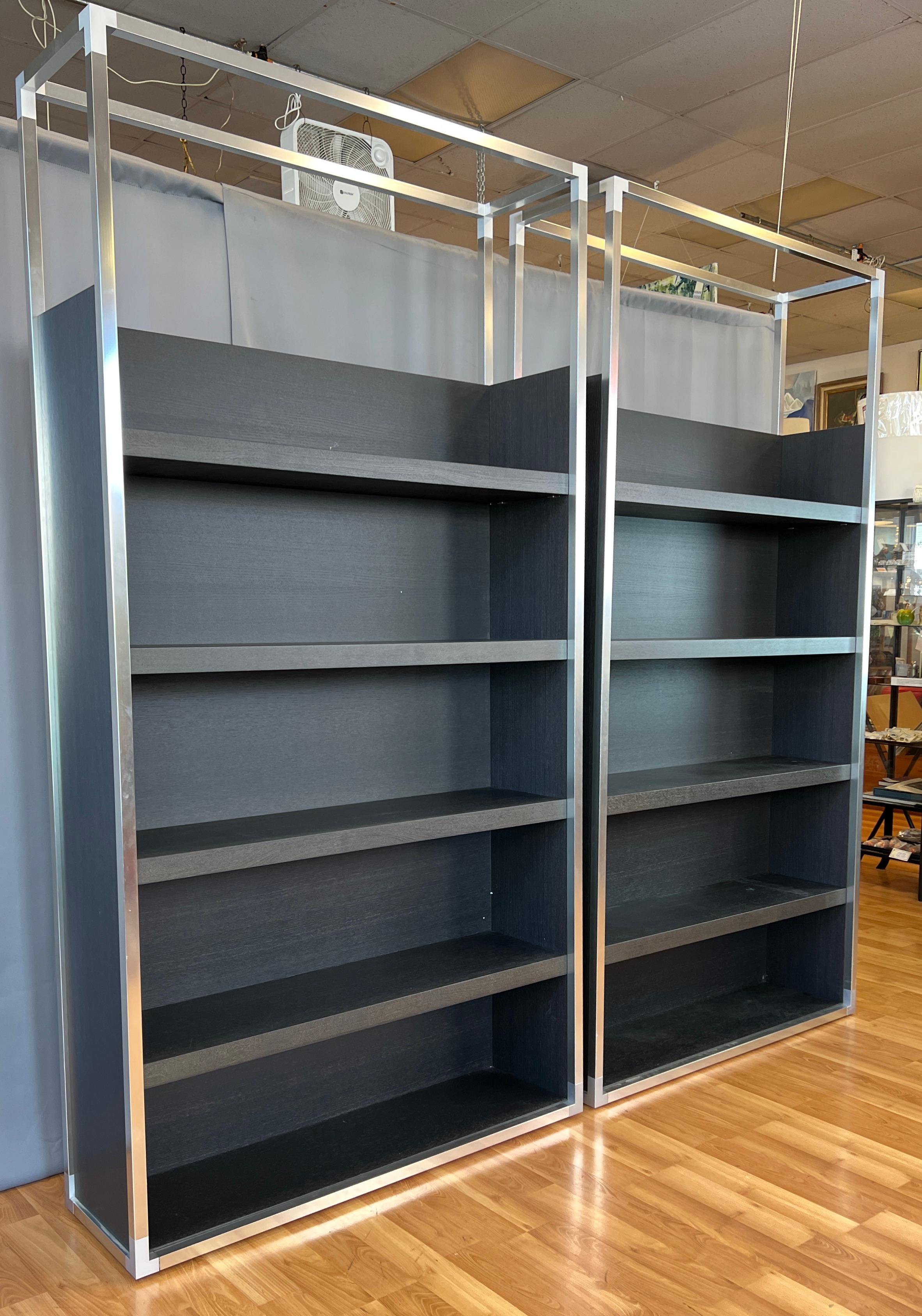 Offered here are two Dedicato Bookcases Designed By Didier Gomez for Ligne Roset.

Each unit looks to be an Ebony Oak, five shelves each starting with the bottom, which are not adjustable.
Top open niche will allow you to display tall art glass,
