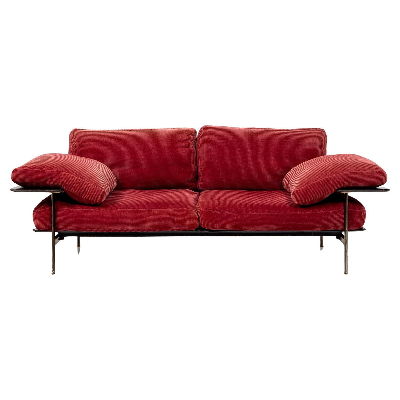 Pair of two-seater sofas, Diesis model, designed by Antonio Citterio and Paolo Nova for B&B Italia. The sofas stand on a metal frame and are fitted with thick cushions. The red upholstery fabric is lightly textured and in good, used condition. The