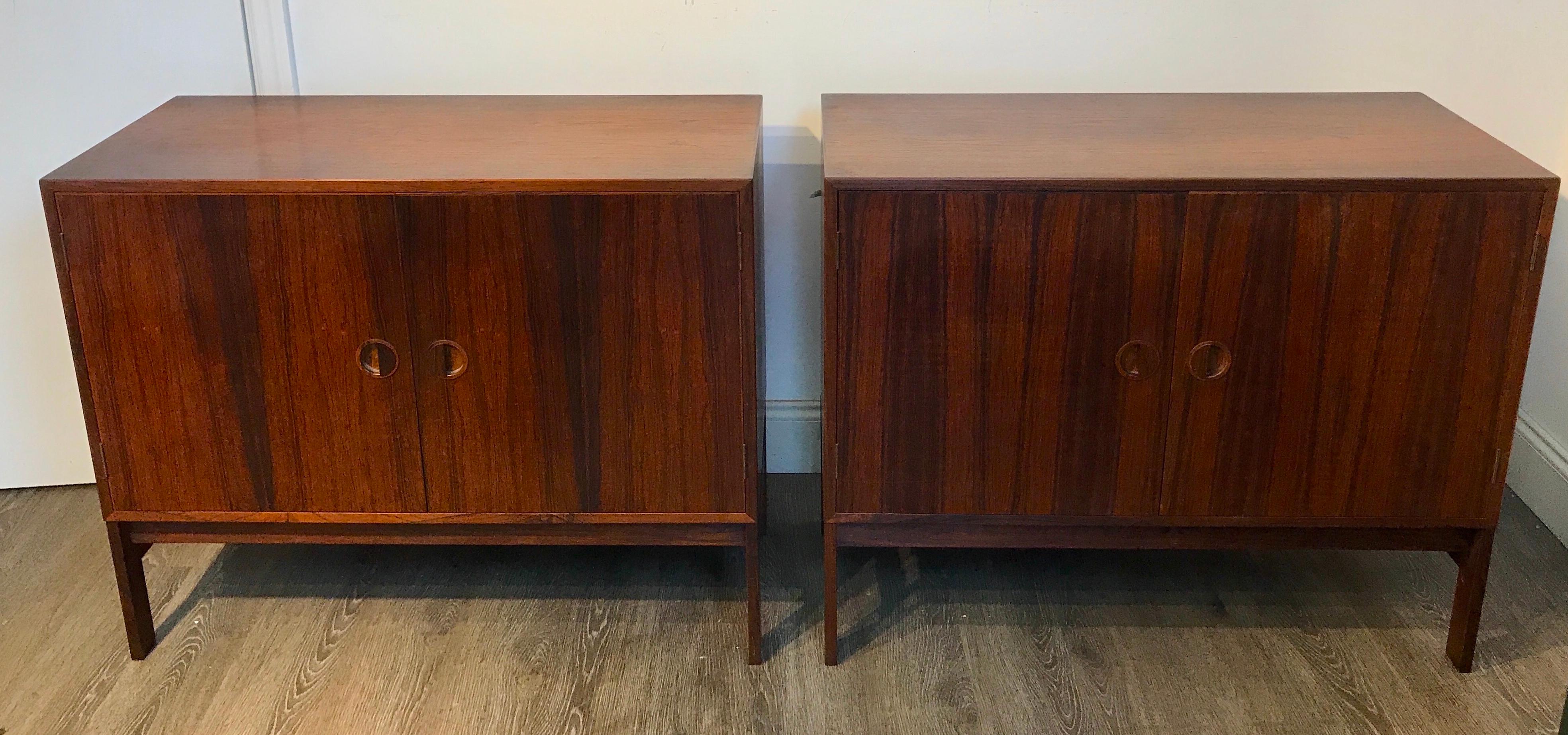 Two diminutive rosewood credenza designed by Ib Kofod-Larsen for Faarup Møbelfabrik, each fitted with two doors revealing a birch interior with two shelves that measure 16.5
