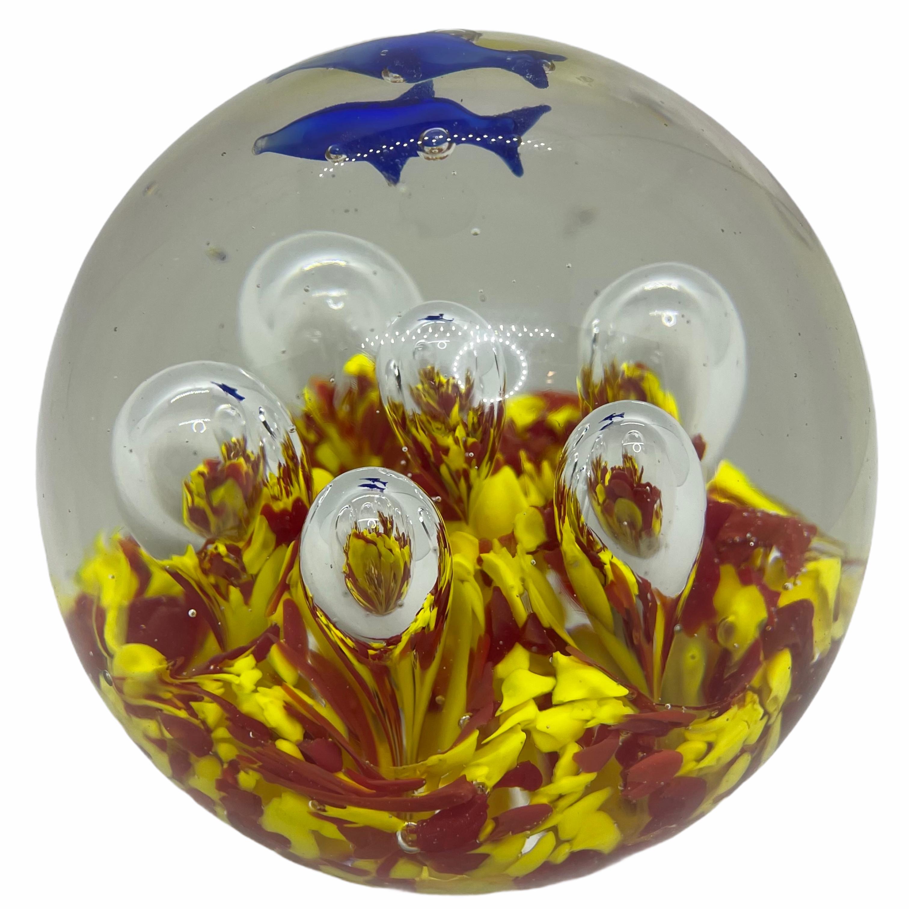 Beautiful Murano hand blown aquarium Italian art glass paper weight. Showing two blue dolphins in a Coral Reef, floating on controlled bubbles. Colors are a blue, yellow and clear. A beautiful nice addition to your desktop or as a center piece in