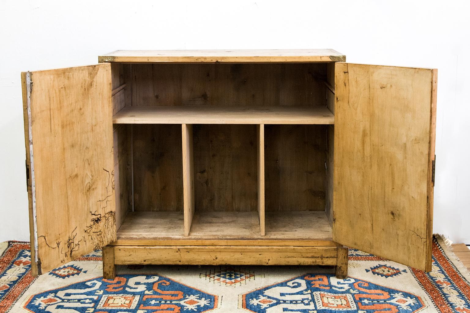 Two-Door Chinese style cabinet, with engraved brass overlays and escutcheons; it has a nice patina on the top and large exposed dove tails on the top edges.


   