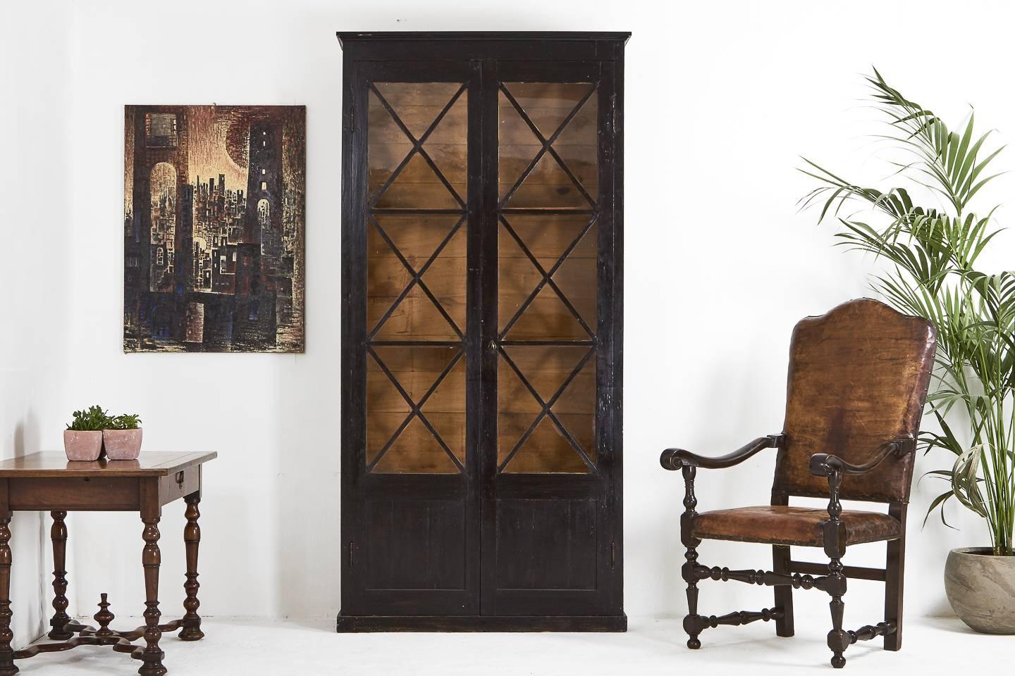 Well proportioned 19th century French ebonised, two-door bookcase or cabinet with nicely patterned glazed doors.
 