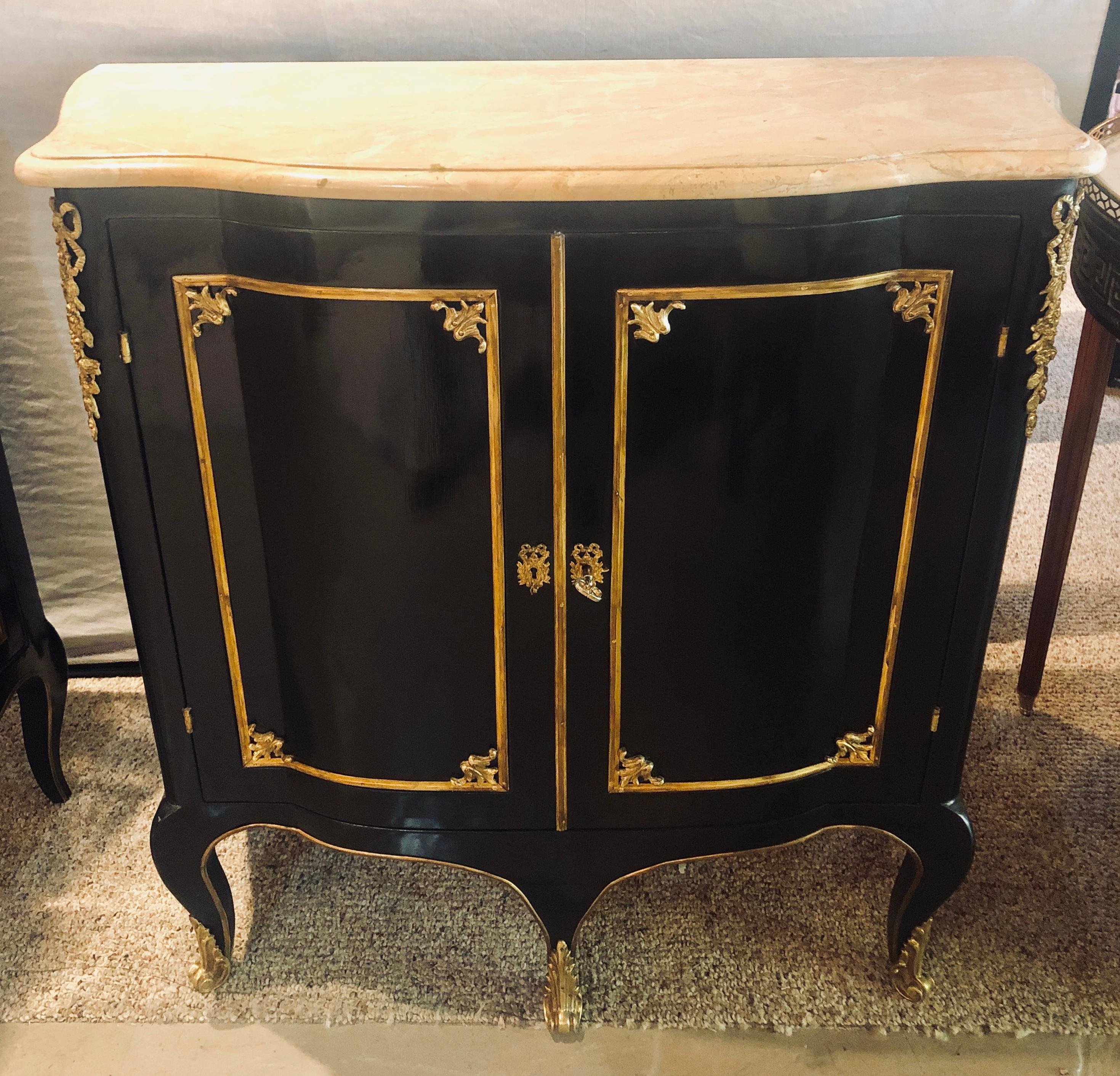 Hollywood Regency style cabinets in manner of Jansen a pair. This fine and custom pair of oak secondary cabinets. Commodes or nightstands have full bronze locks and fitted shelf interiors. The ebony finish having double serpentine fronts with bronze