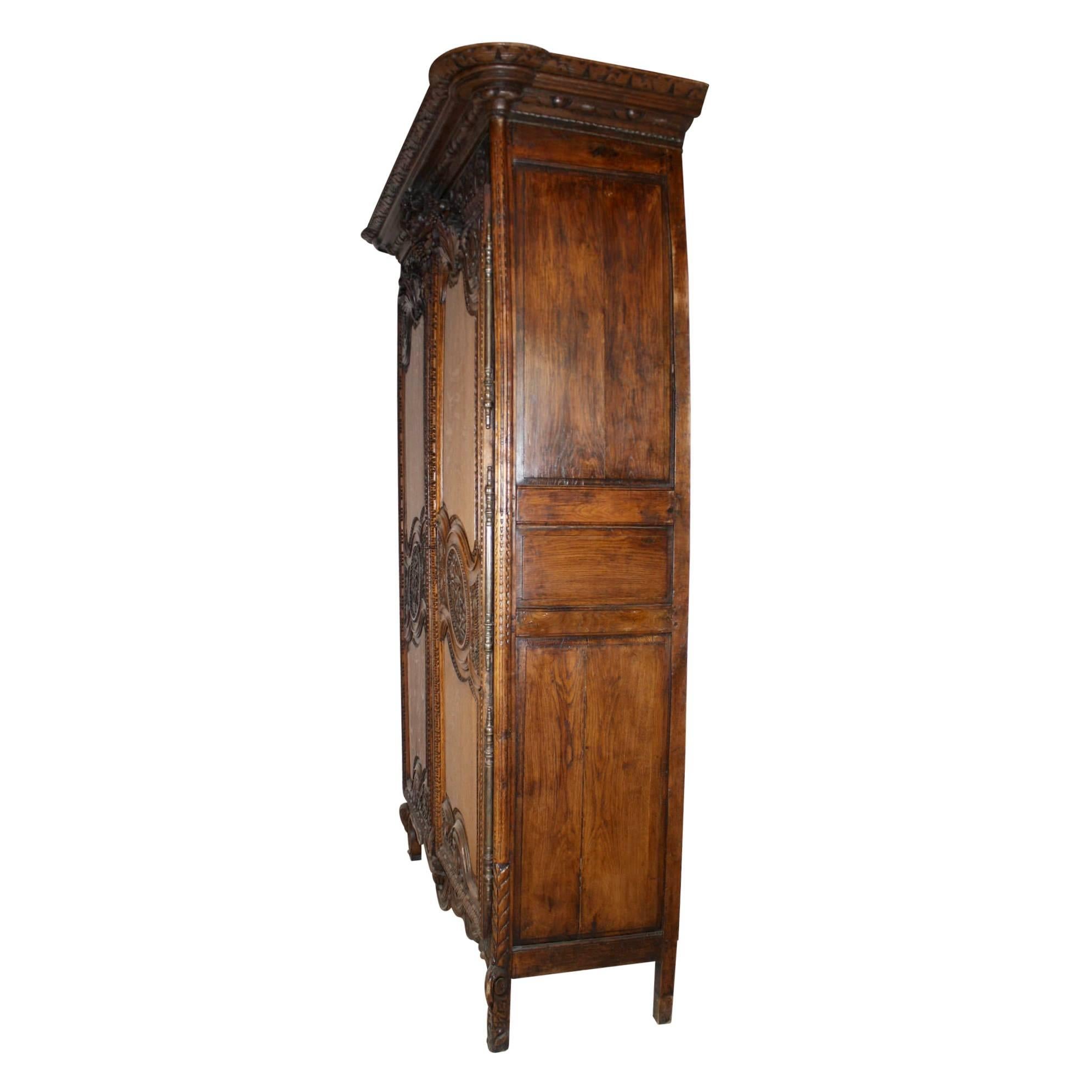 The French custom of a father's gift to his newborn daughter was the crafting or purchase of an armoire carved with symbols of plenty and happiness, which stored her trousseau to use in her own home once she married. This beautifully carved,