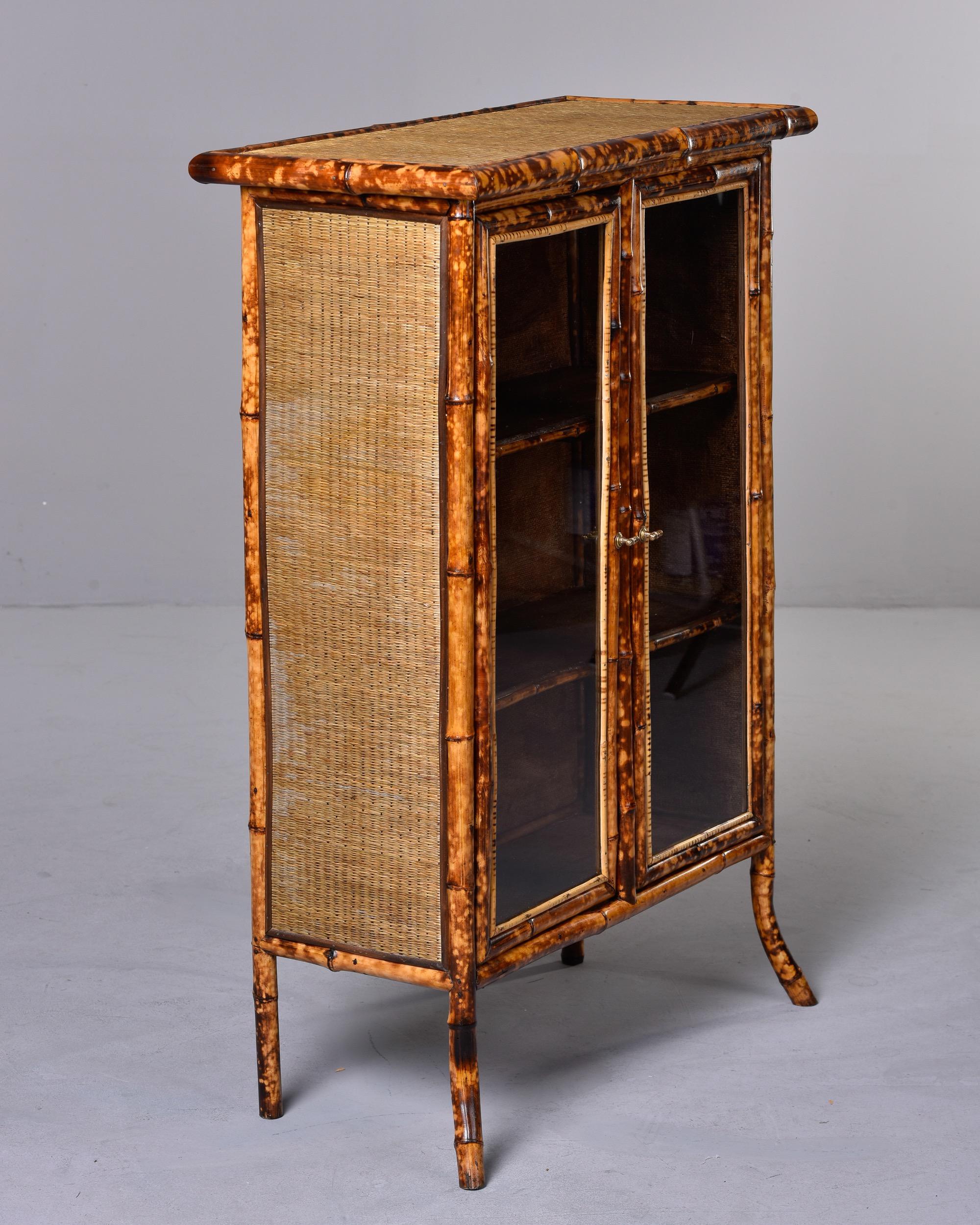 English Two Door Glass Front Cabinet with Spotted Bamboo Frame