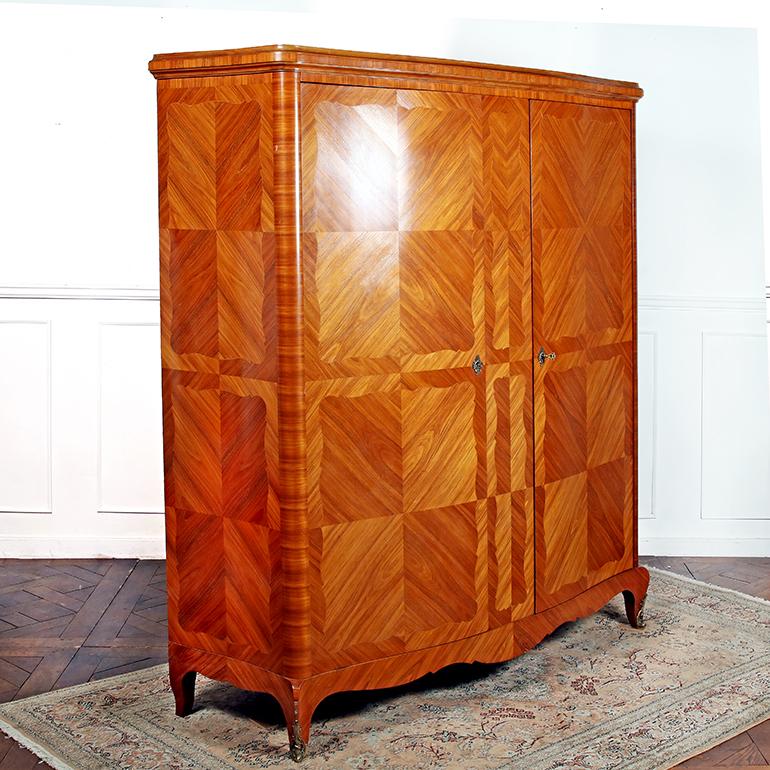 An early 20th century French, Louis XV Style, two-door armoire, featuring parquetry in a striking and warm Kingwood. The wood has such depth that the pattern almost seems to change in different light – one must really see it in person to appreciate