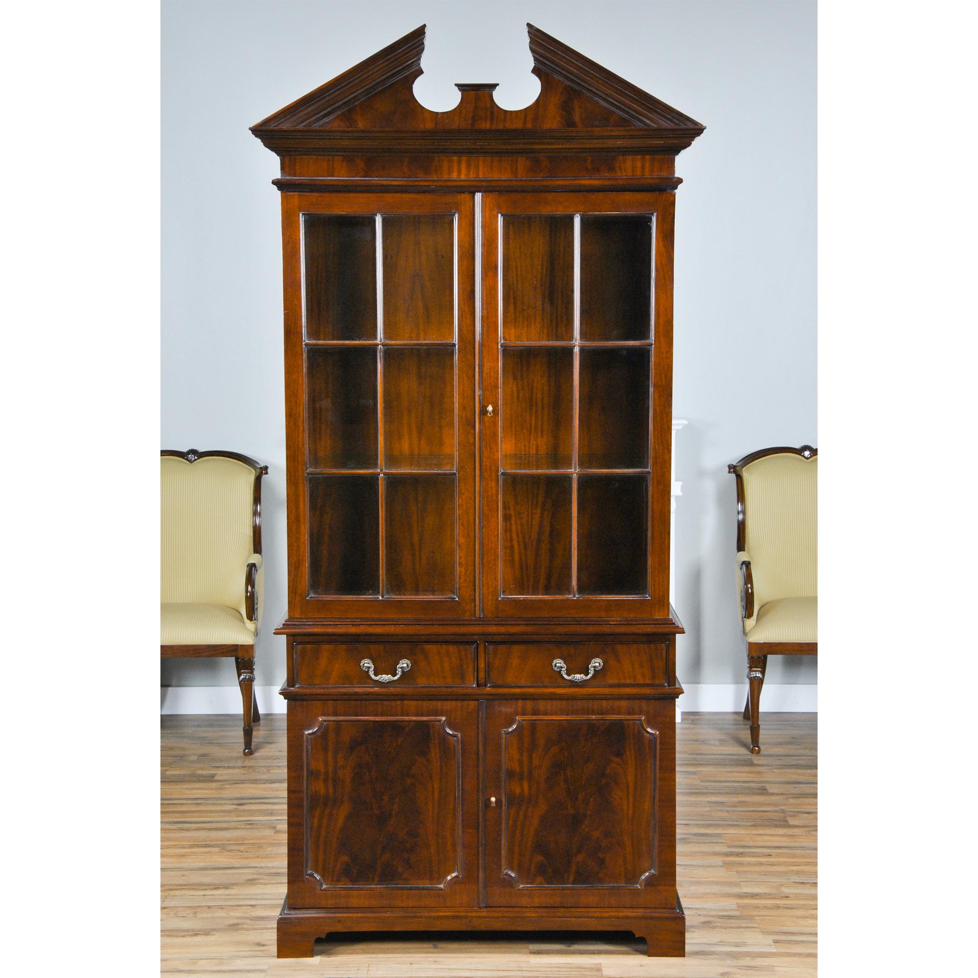 Ideal for narrow spaces this Two Door Mahogany China Closet can fit when our larger cabinets cannot make it between a set of doorways, windows, radiators, etc. Thick glass shelves in the upper section allow light to penetrate and help show off your
